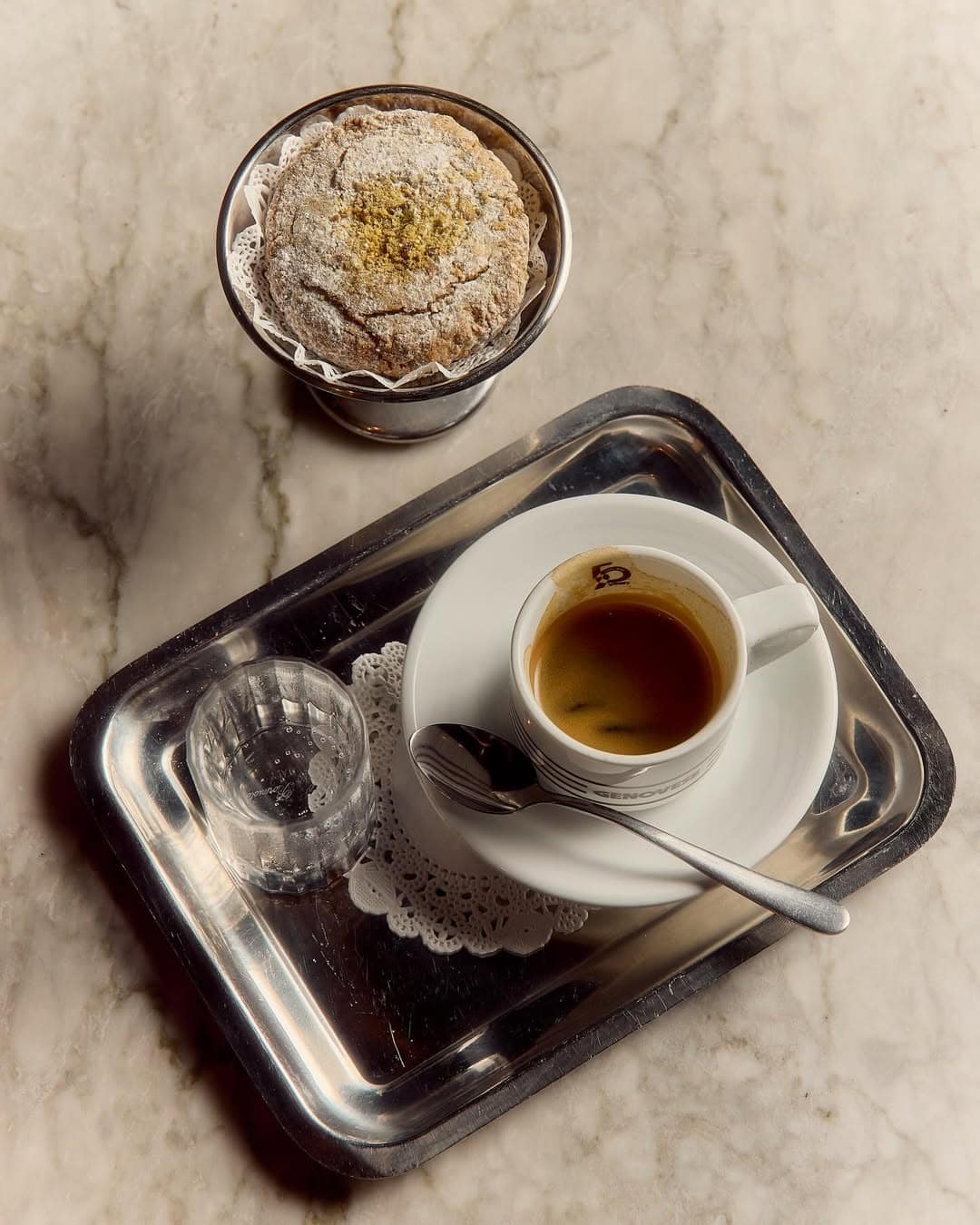 An espresso on a silver tray plus a cake at Genovese in Alexandria.