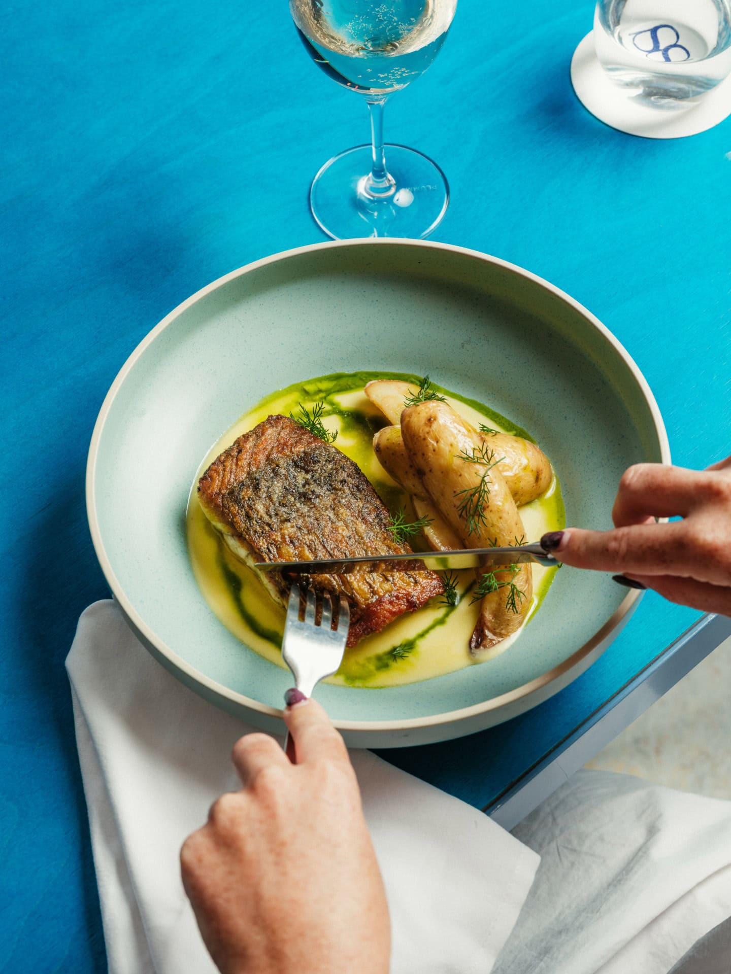 Someone tucking into a plate of fish at Summer Salt in Cronulla.
