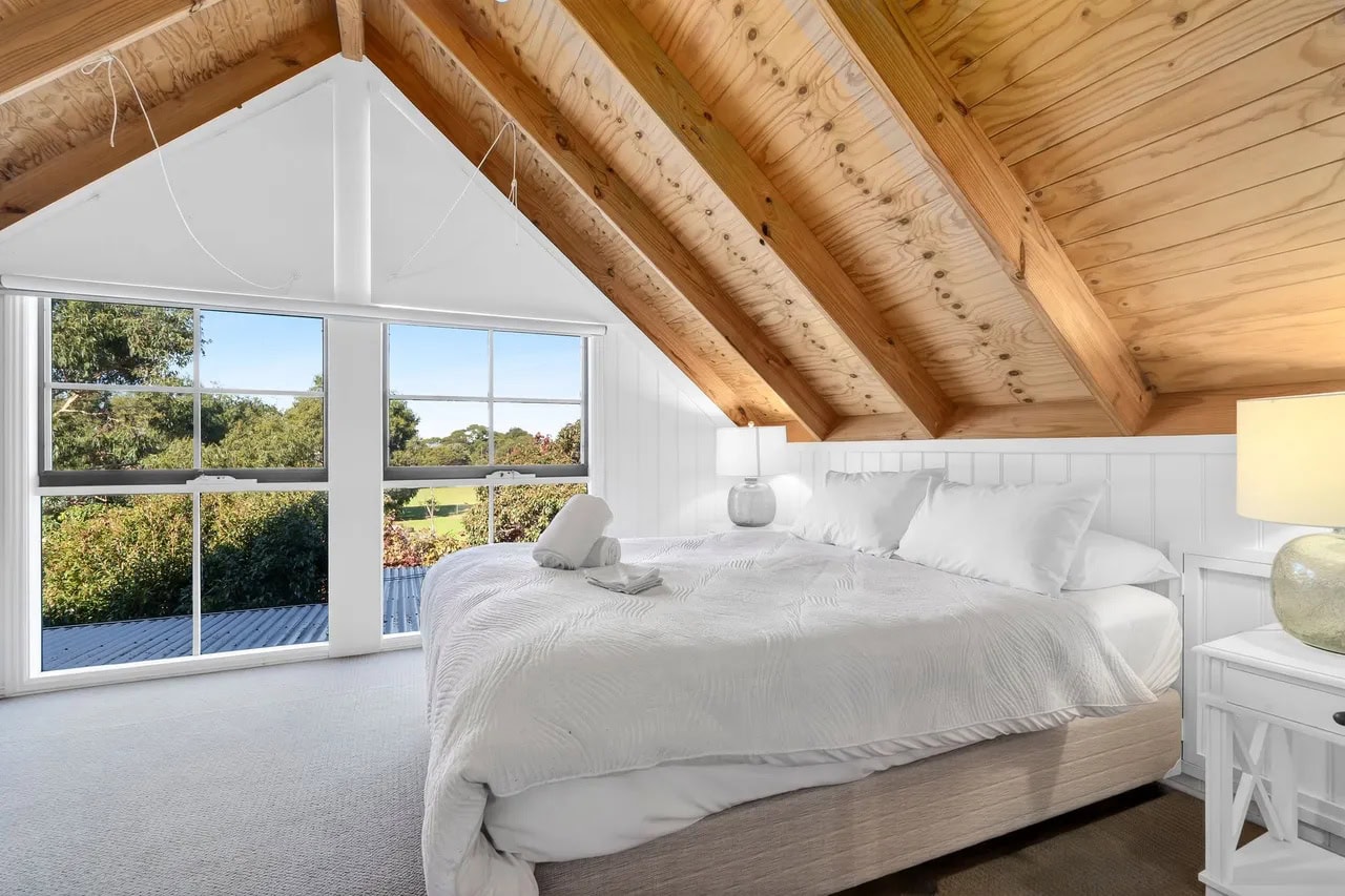 Sunlit bedroom inside The Great Escape coastal house in Marengo