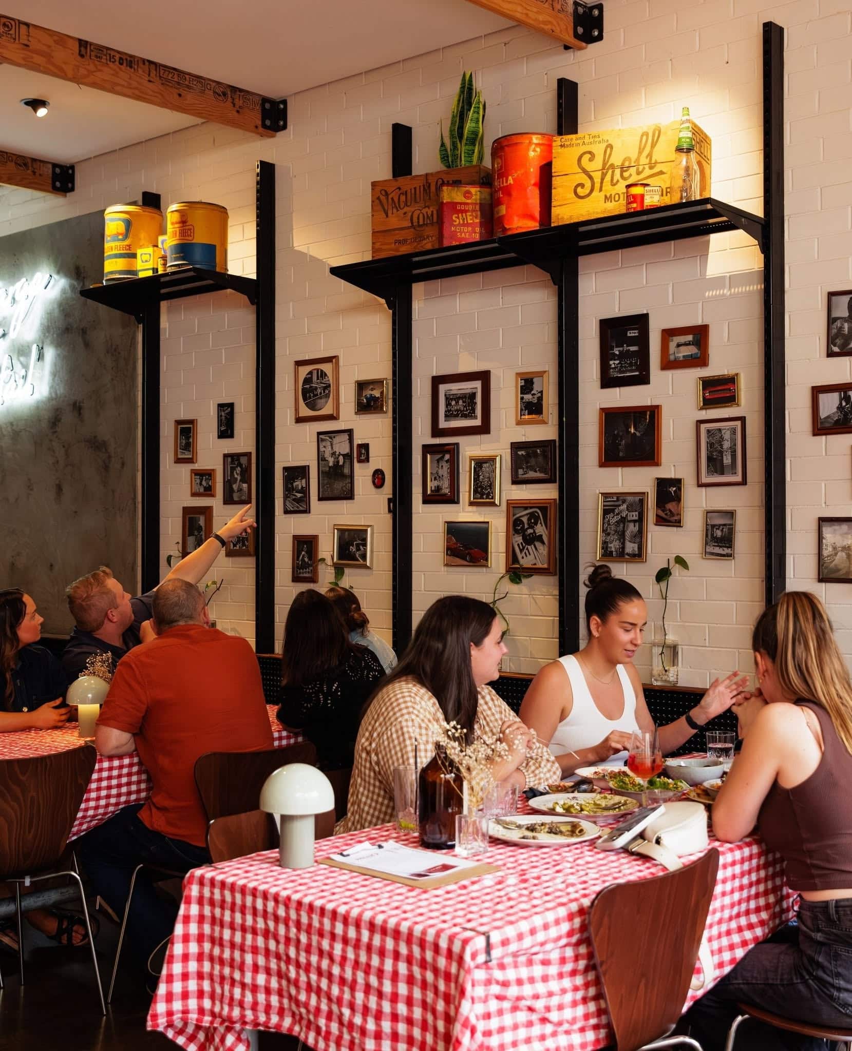 Diners sharing plates around red gingham-covered tables inside Holly’s restaurant in Ringwood.