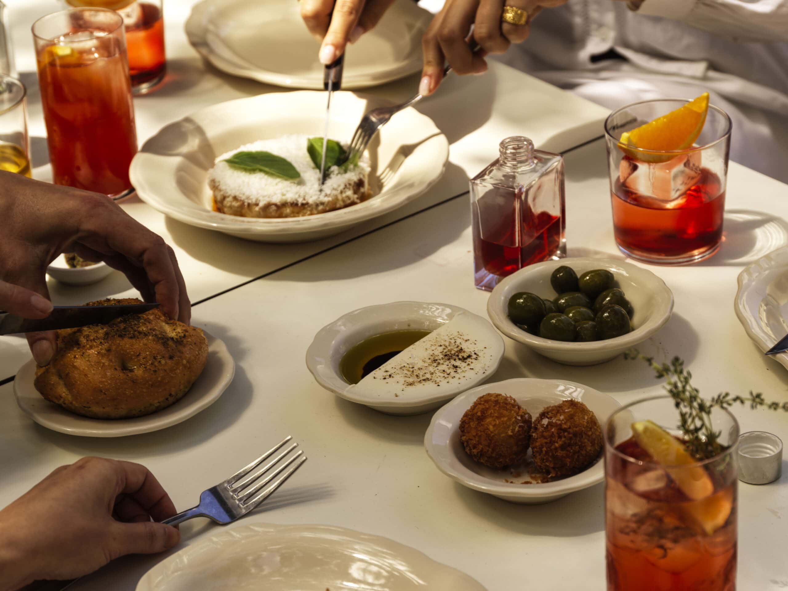 Italian antipasti spread with arancini, olives, burrata and negronis at Vin-Cenzo's, Darlinghurst, Sydney