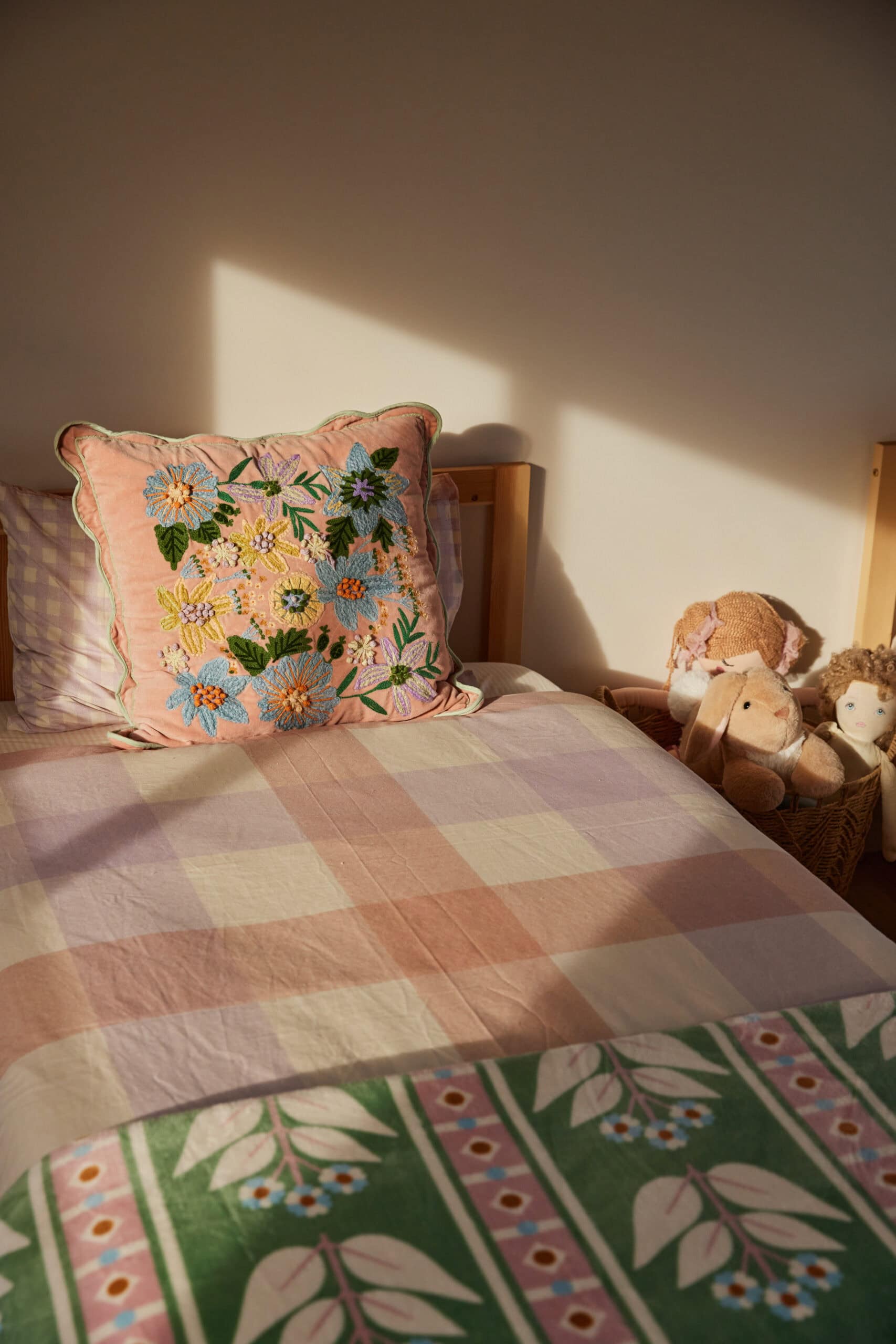 Girls bedroom decor with sunlight shining and toys in basket