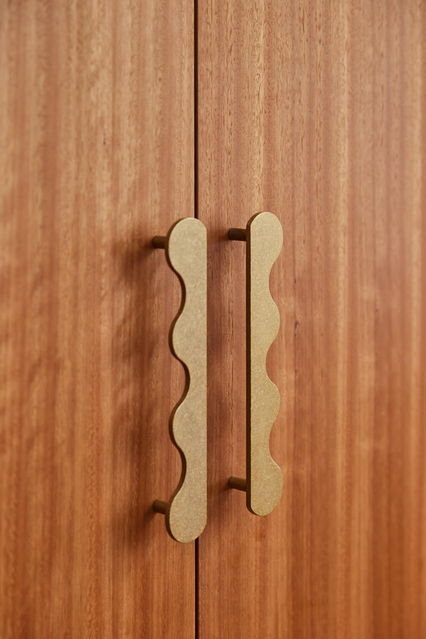 Close up kitchen cabinet handles, wavy brushed metal.