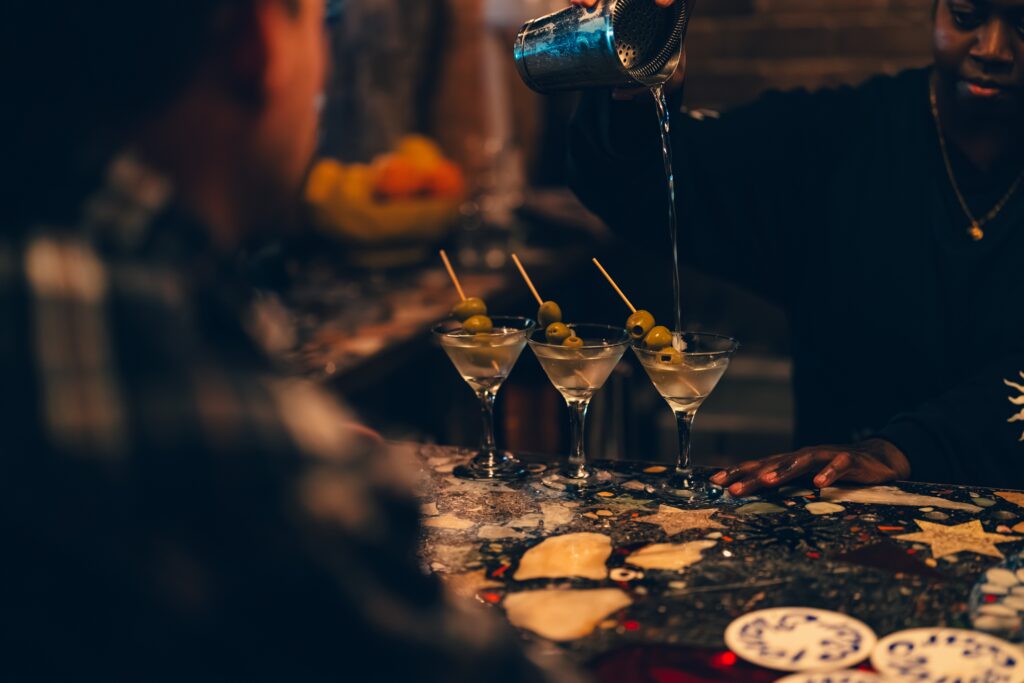 Martinis with olive garnish being poured at Bar Planet Newtown Sydney