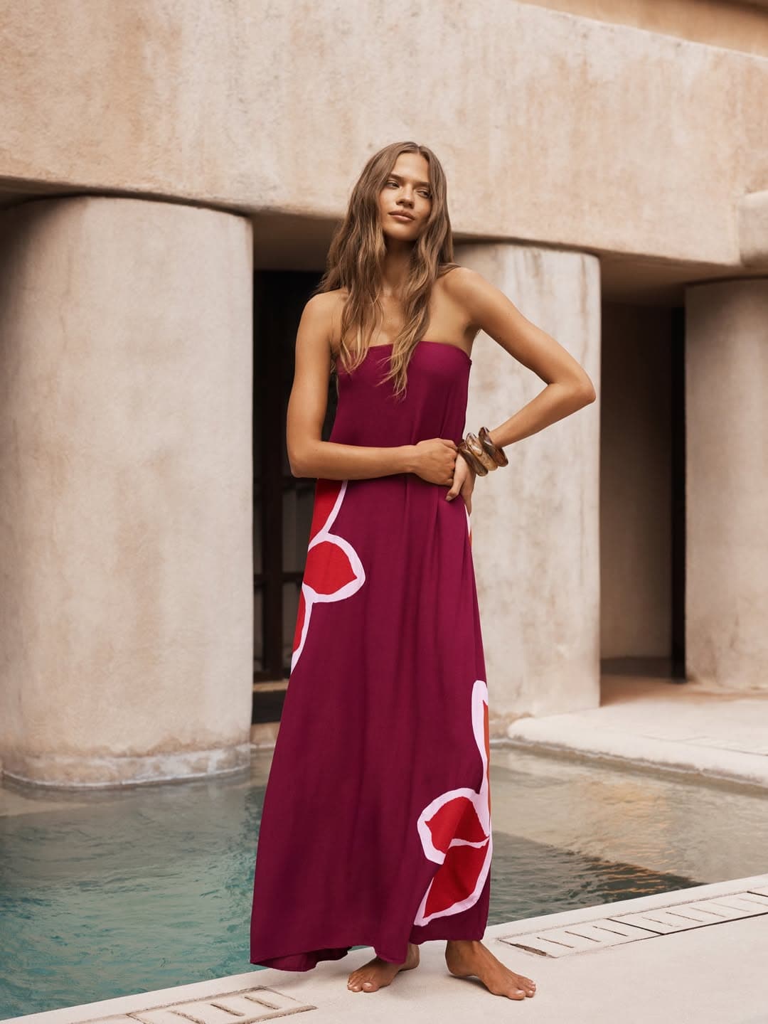 A woman in a maroon maxi from Mister Zimi in Byron Bay.