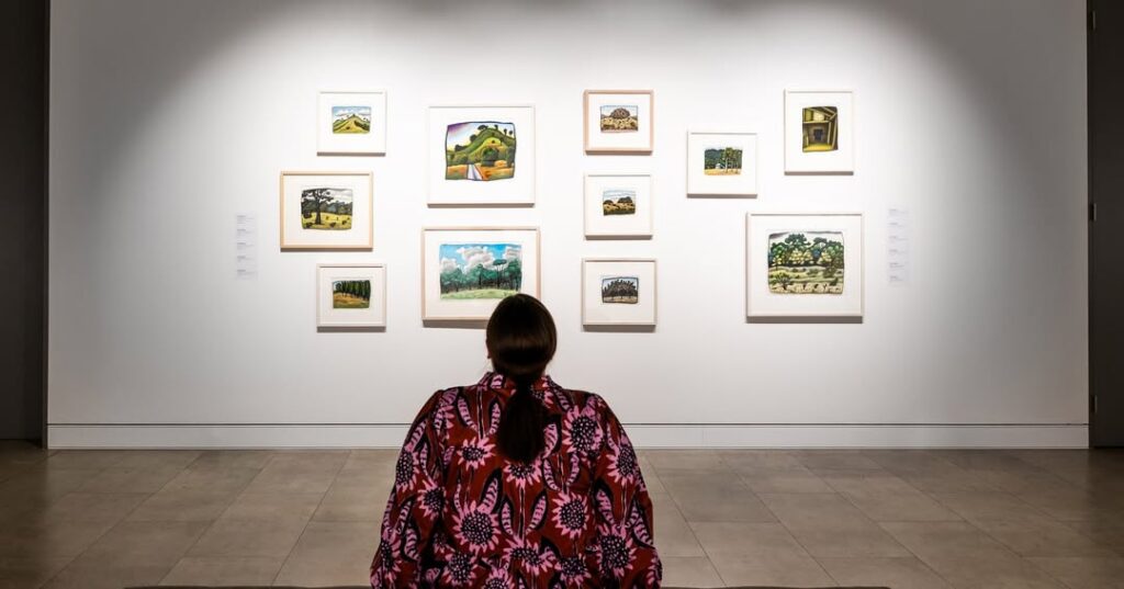 A woman looking at an installation of images at Mudgee Arts Precinct.