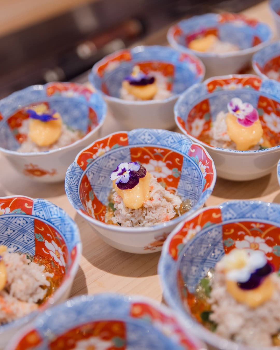 Decorated Japanese bowls holding individual portions at Green Shiso Omakase in Sydney.