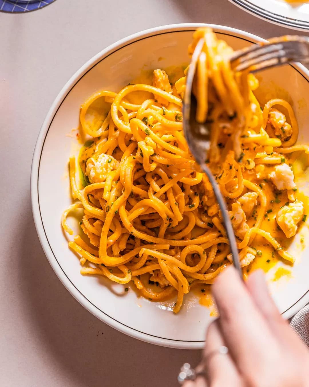 Someone using a fork to twirl pasta at Fabbrica.