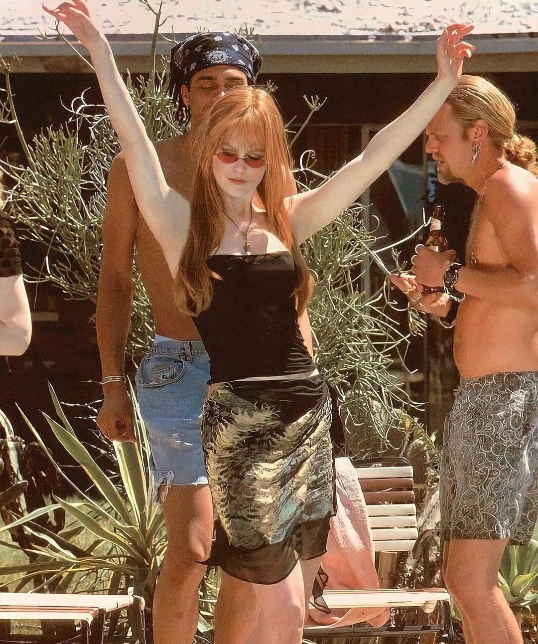 Nicole Kidman in Practical Magic dressed in a sarong dancing by the pool