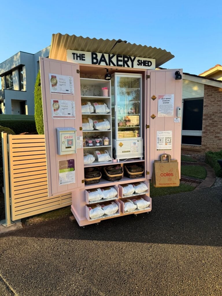 Pink self-serve bakery shed stocked with bread and cookies at The Bakery Shed Quakers Hill Sydney