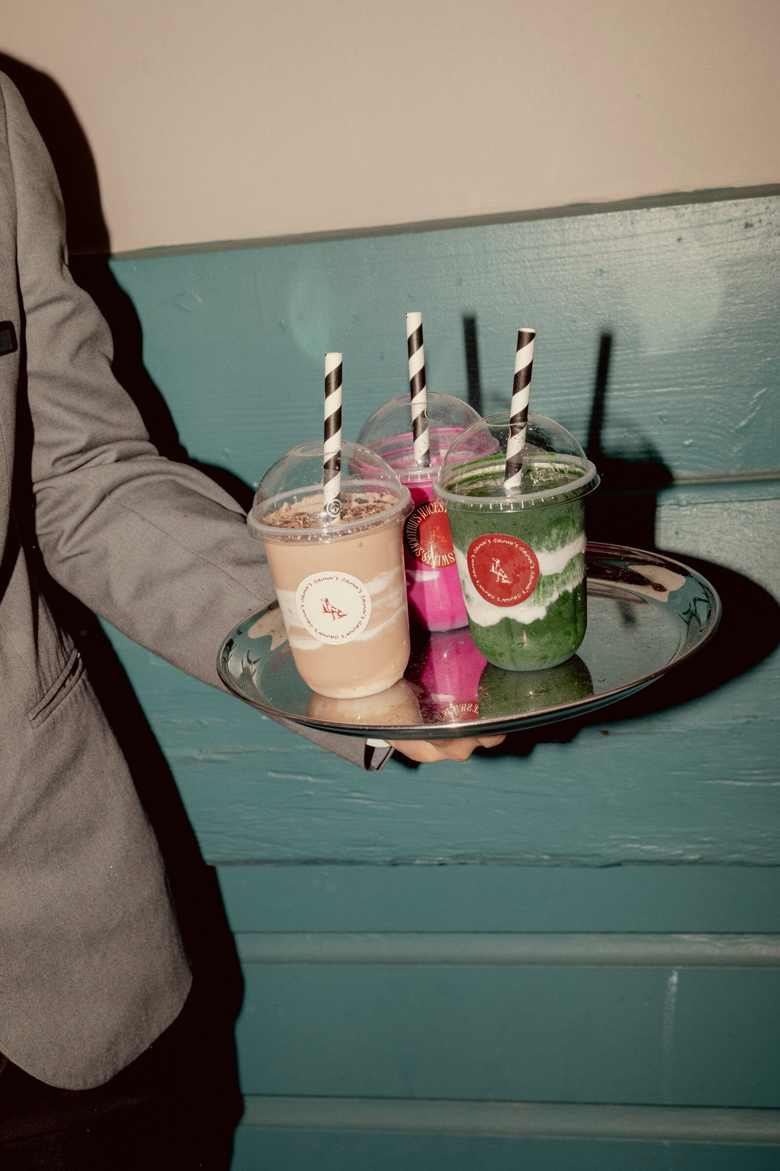 Chocolate, pink and green smoothies with striped straws on a silver tray at Bruno's, Finger Wharf Woolloomooloo Sydney