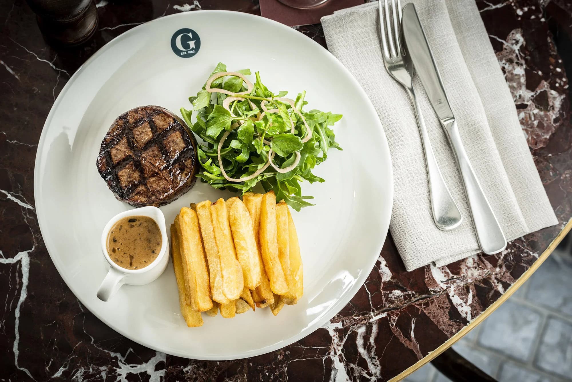 Grilled steak with fries, rocket salad and pepper sauce at The Glebe Hotel, Glebe, Sydney
