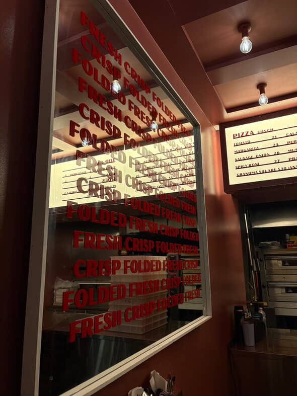 Fresh Crisp Folded window signage and pizza menu at Pizza Laundry Sydney CBD