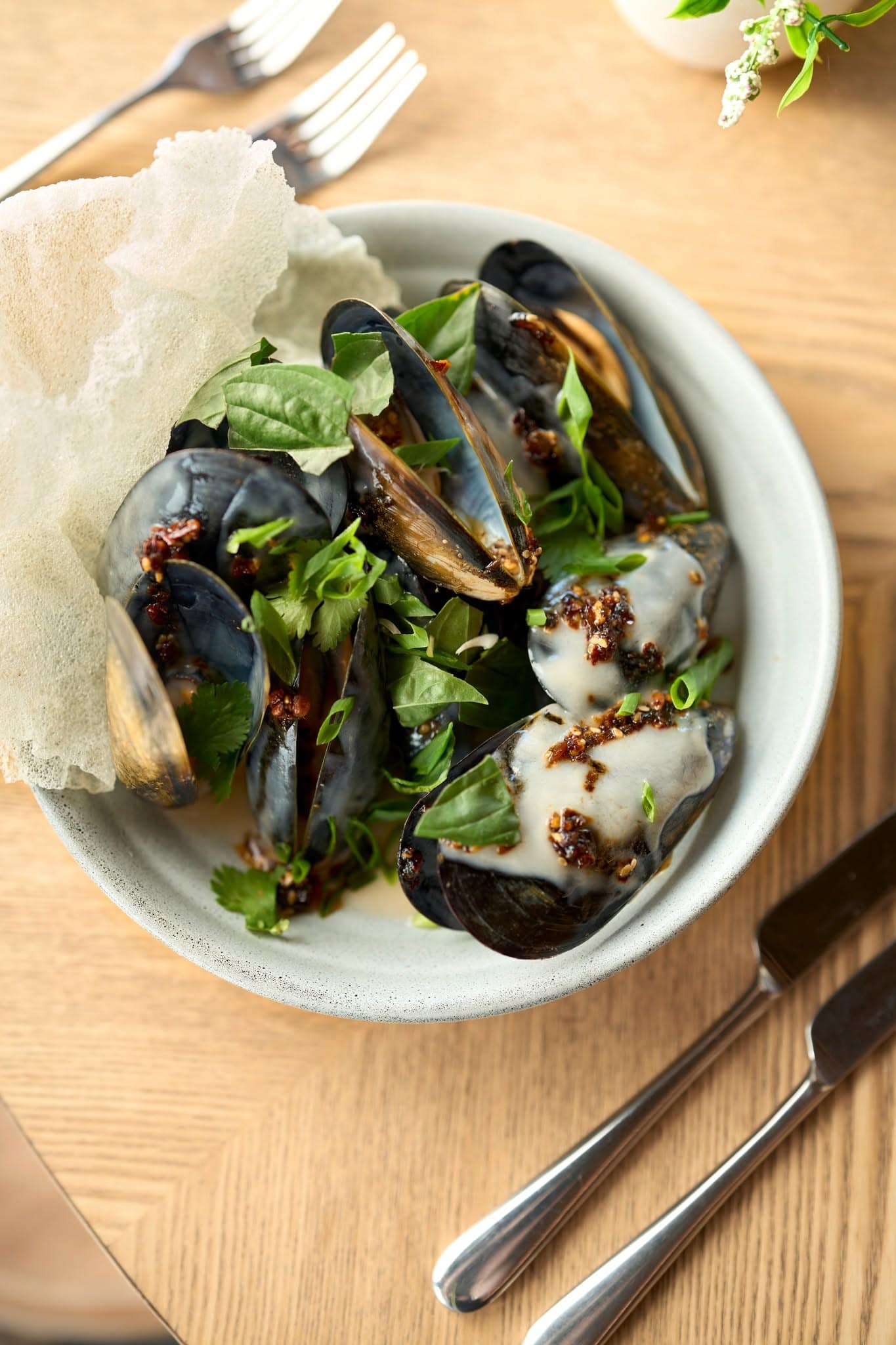 Mussels with fresh herbs and crisp rice crackers served at Claribeaux restaurant in Torquay, Victoria.