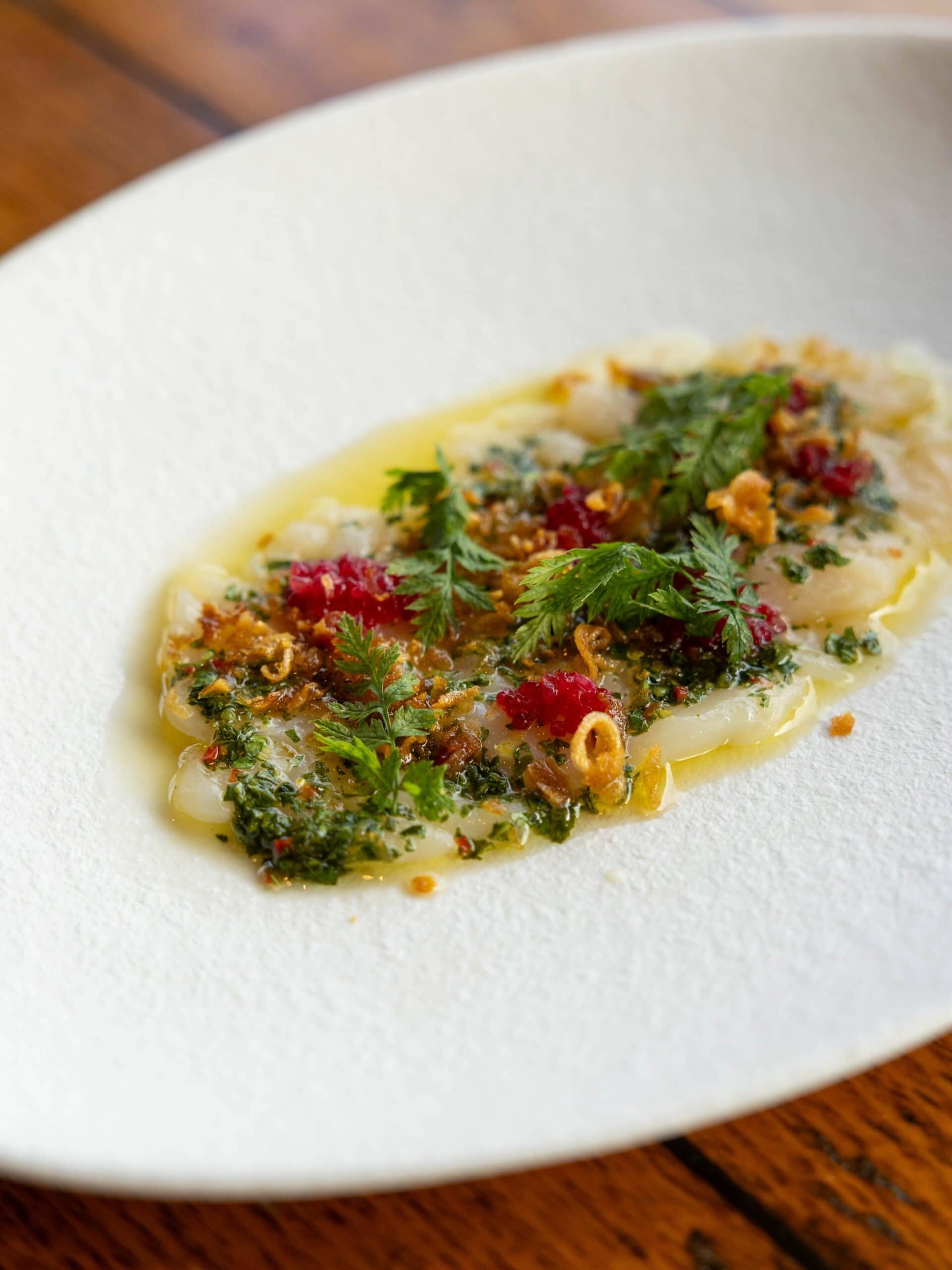 Delicate scallop dish with herbs, chilli and citrus dressing at Donovans restaurant in St Kilda, Melbourne.