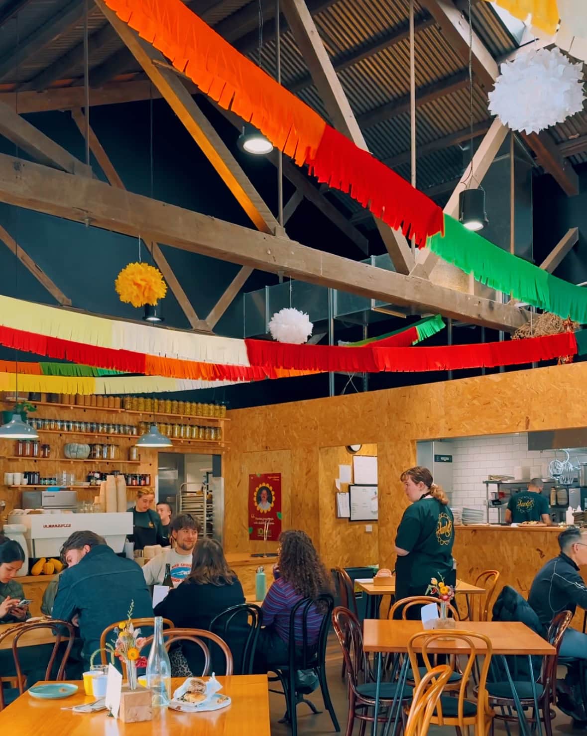 the warm and cheery interiors and people at tables having brunch at Hamlet cafe in Hobart