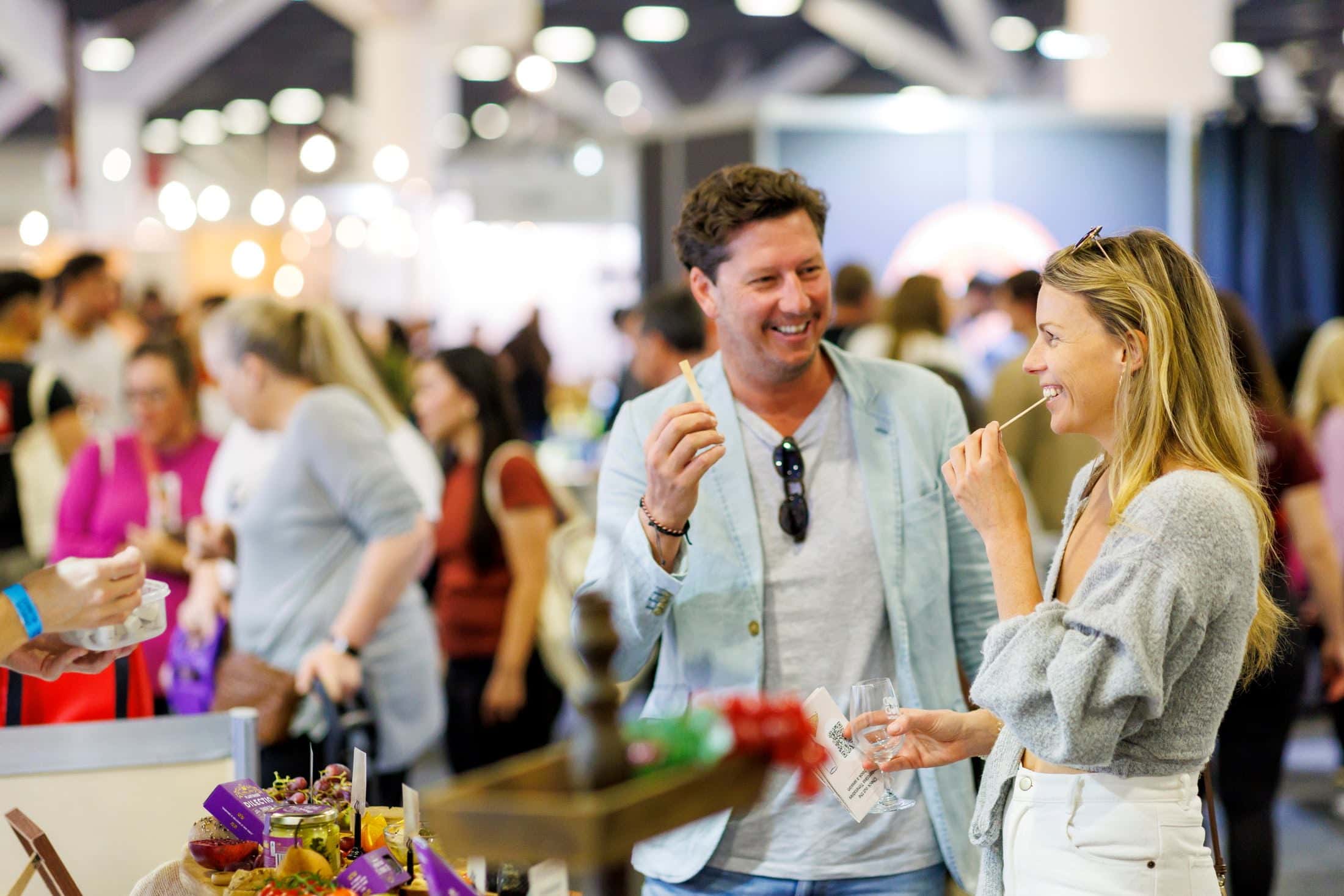 Two people sampling food at The Good Food & Wine Show