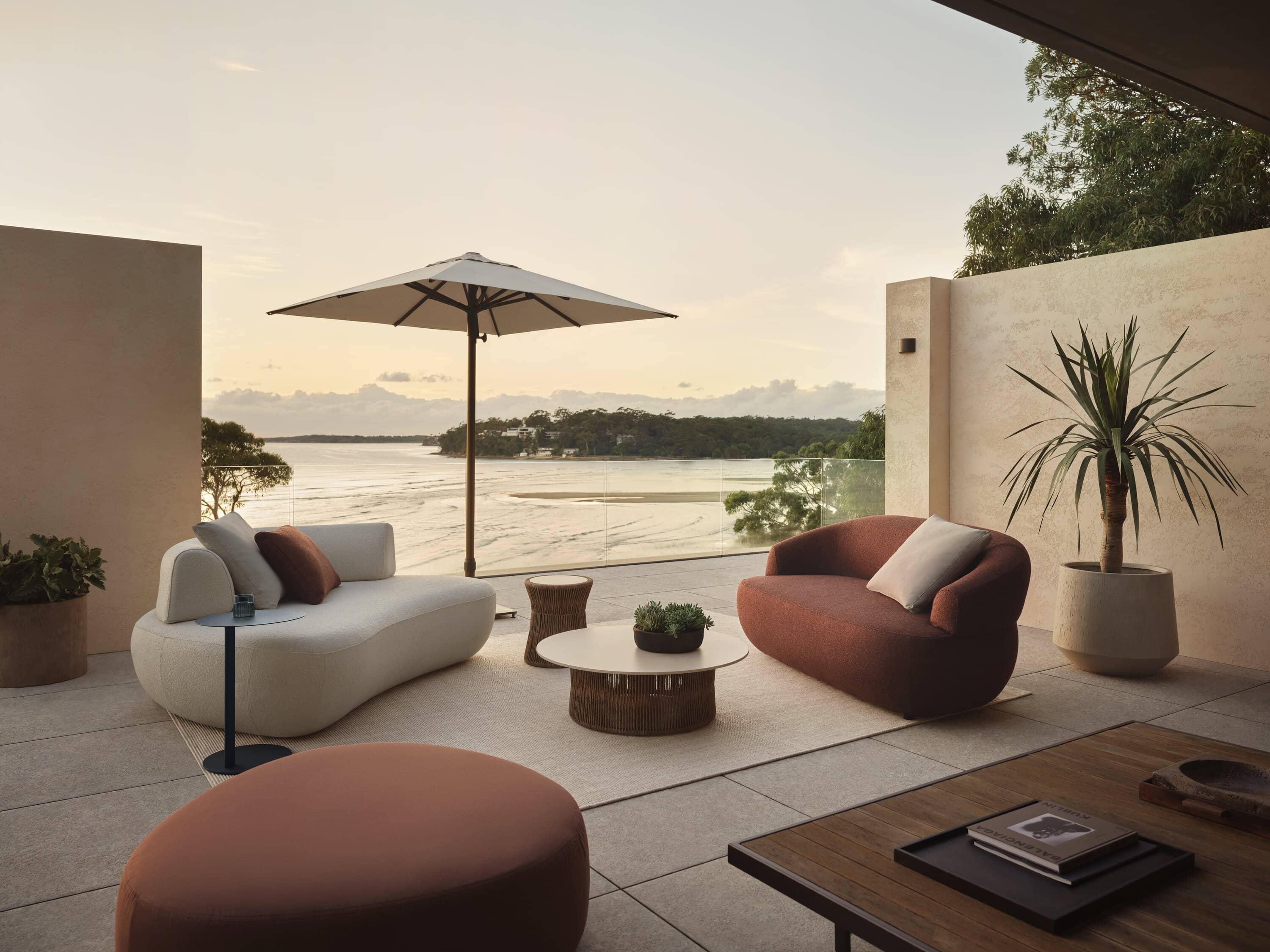 Aura outdoor 2-seater sofas by King Living styled on a waterfront terrace