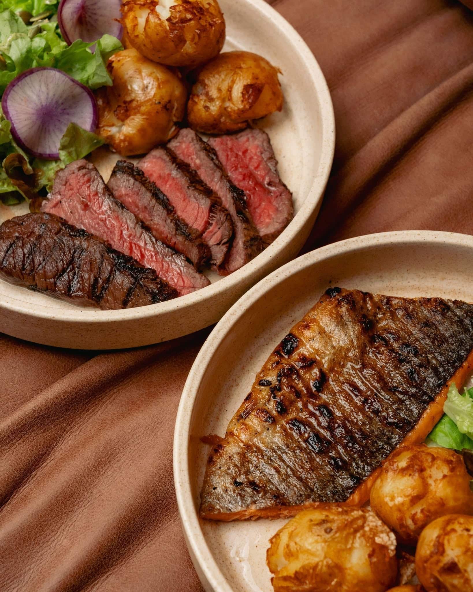 Chargrilled steak and fish with roasted potatoes and salad at Pastuso in Melbourne CBD.