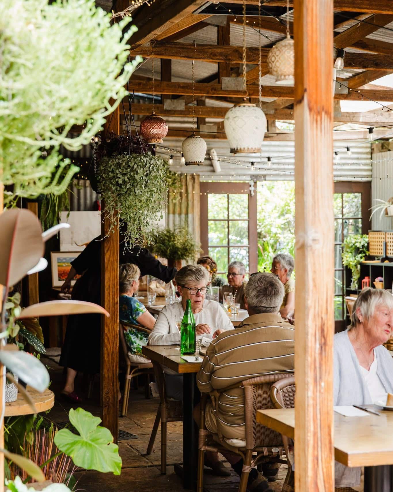 Diners inside the leafy garden dining area at Pickled Sisters in Rutherglen, one of North East Victoria’s popular restaurants.