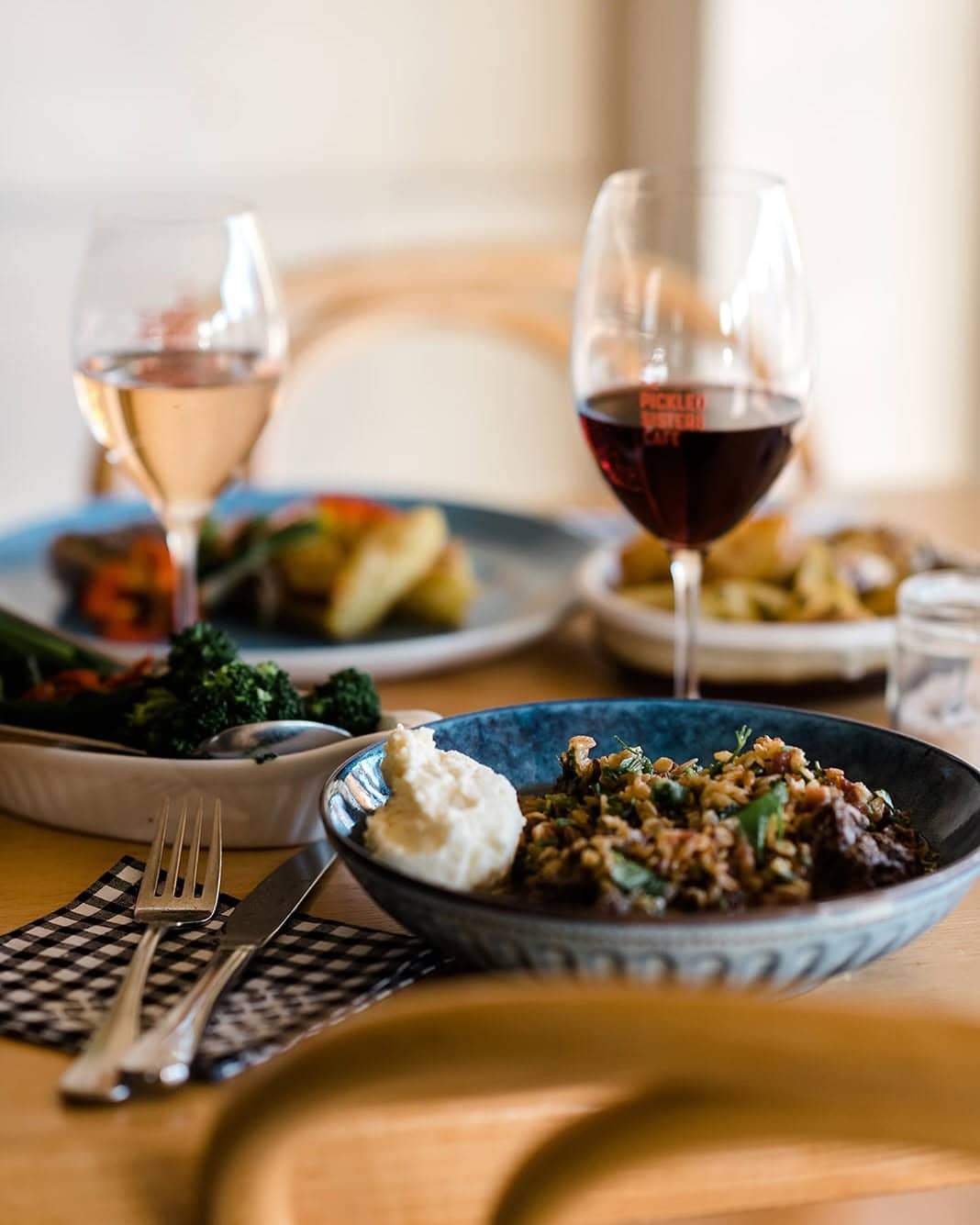 Seasonal dishes served with red and white wine at Pickled Sisters, a Rutherglen restaurant celebrating regional produce.