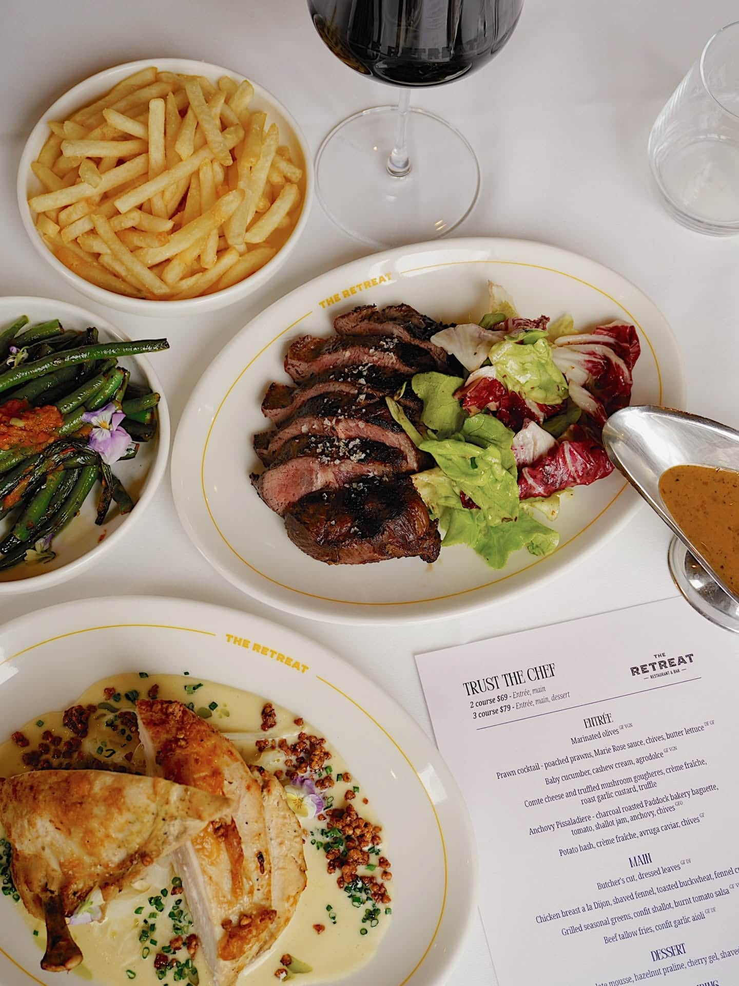 Modern Australian mains including grilled steak, roast chicken, fries and seasonal greens at The Retreat Restaurant & Bar in Geelong.