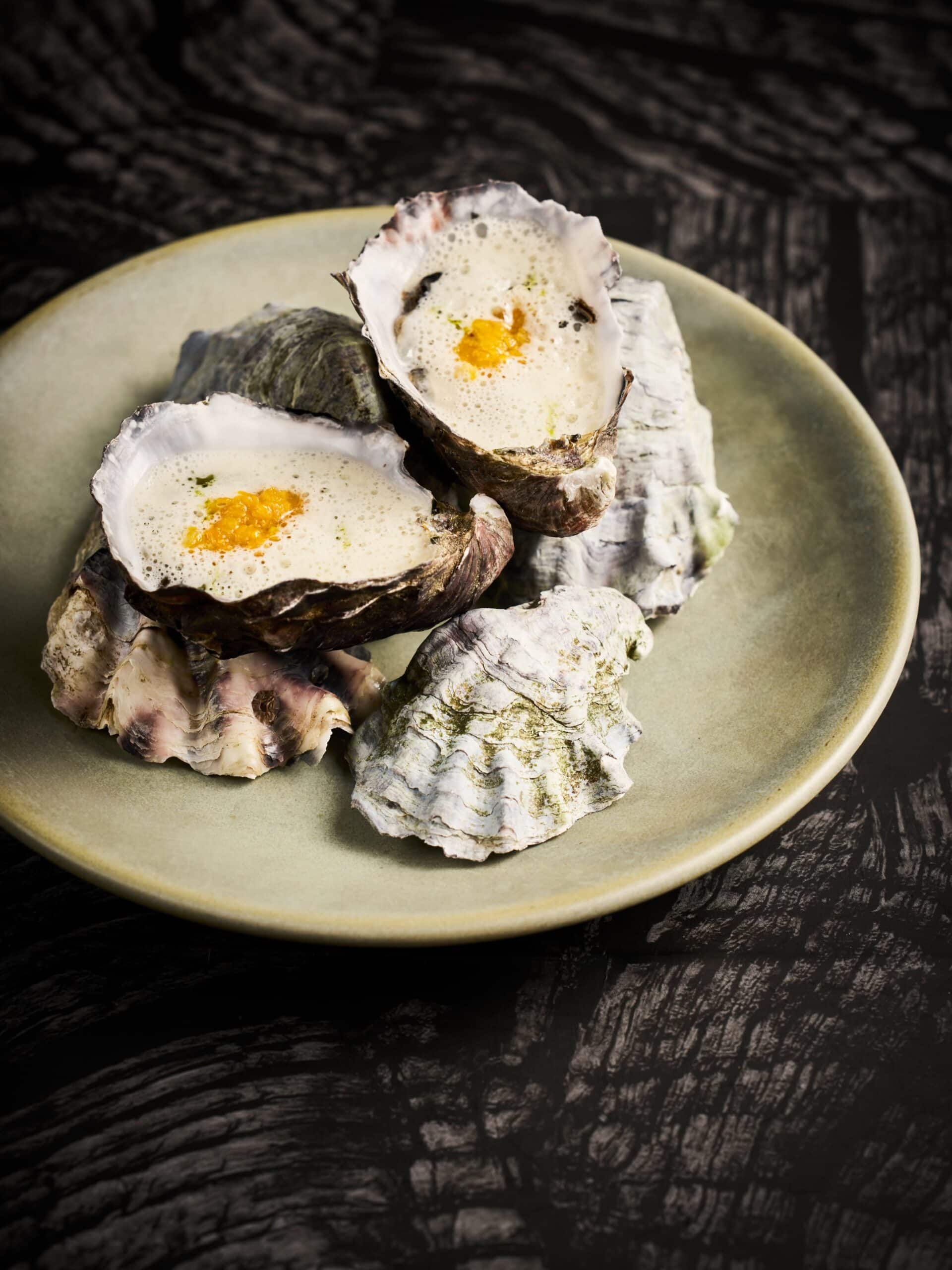 Oysters served with a light foamy sauce at The Woodhouse, a contemporary restaurant in Bendigo, Victoria.