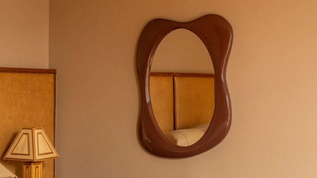 Red glossy wall mirror from RJ Living with curved shape