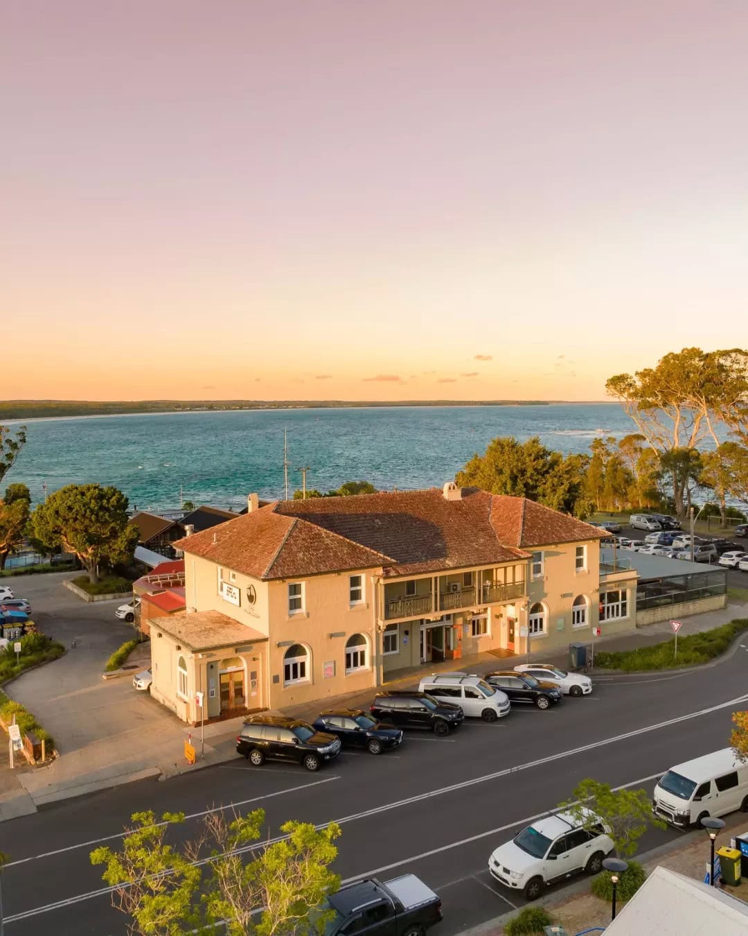 An aerial view of Huskisson Hotel at dusk.