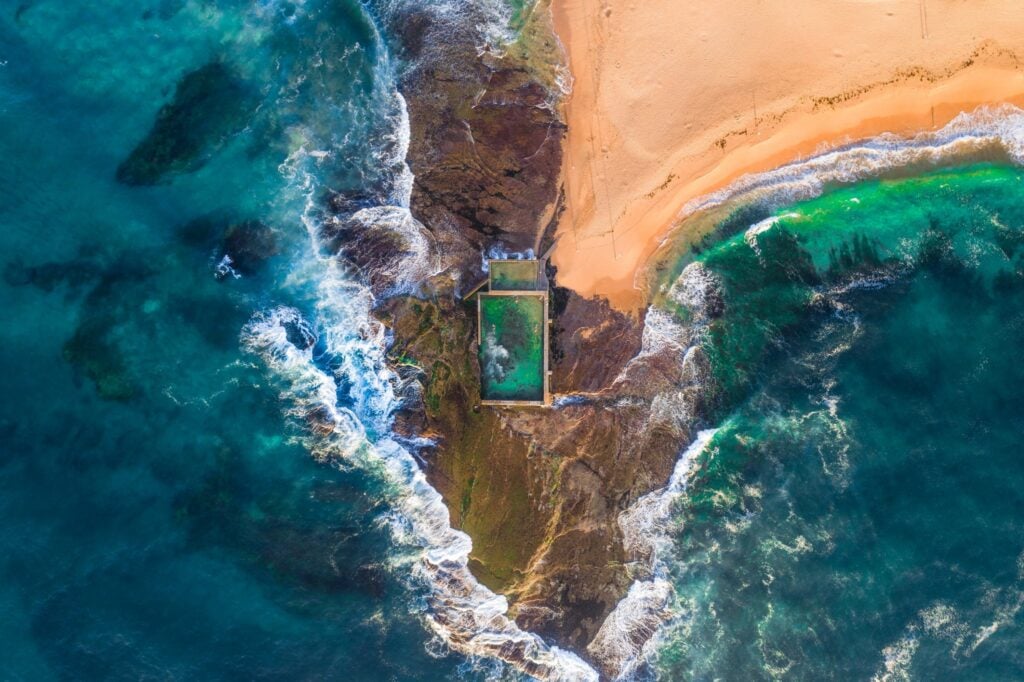 Aerial view of Mona Vale Rockpool on a rocky headland beside the beach in Mona Vale Sydney
