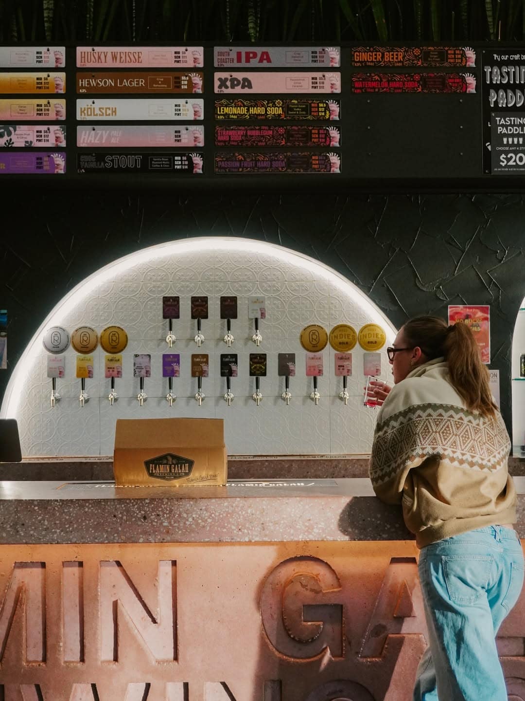 A woman waiting at the bar at Flamin' Galah brewery in Jervis Bay.