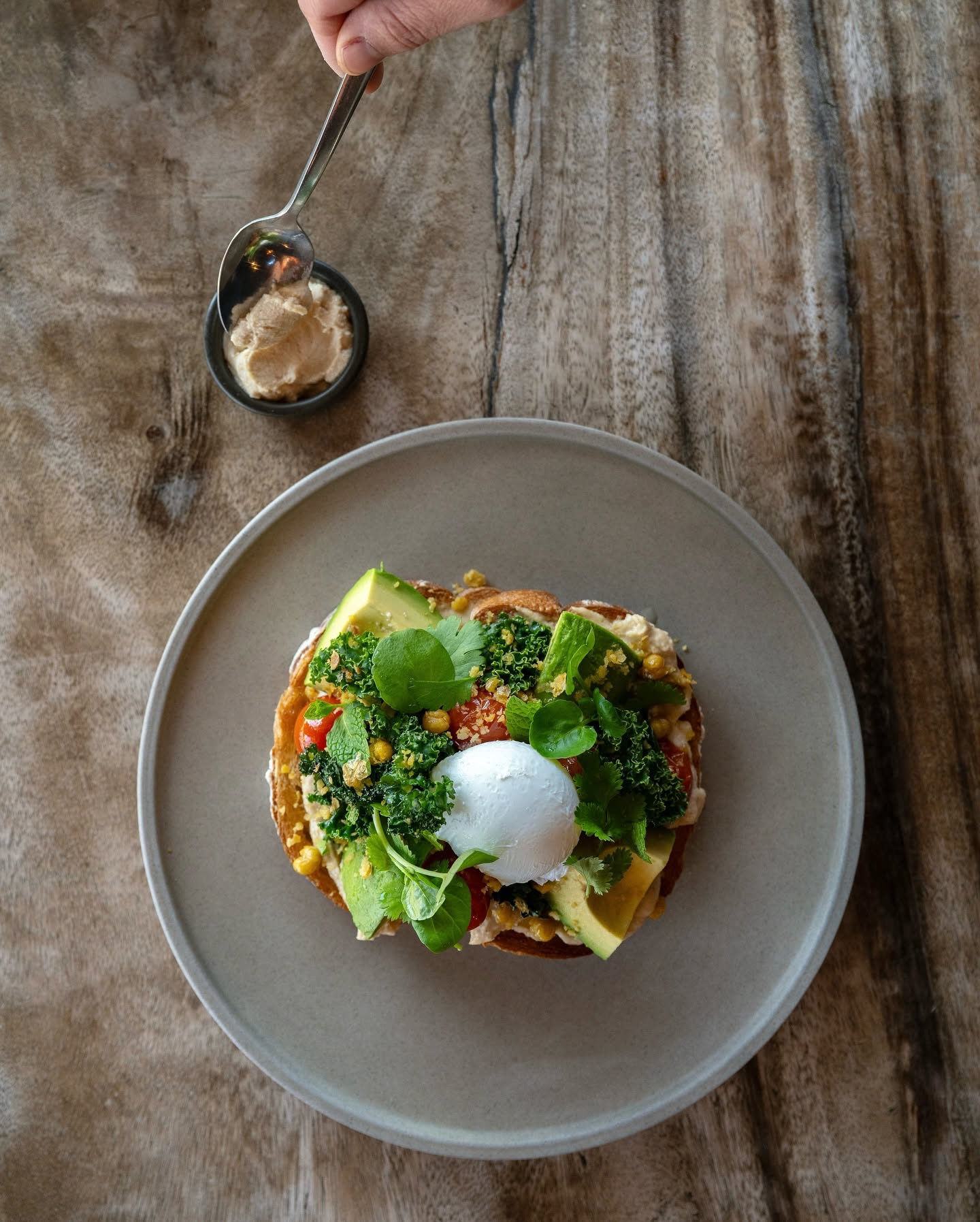 Avocado toast topped with poached egg, kale and fresh herbs at Brass Monkey, a popular cafe in Mildura, Victoria.