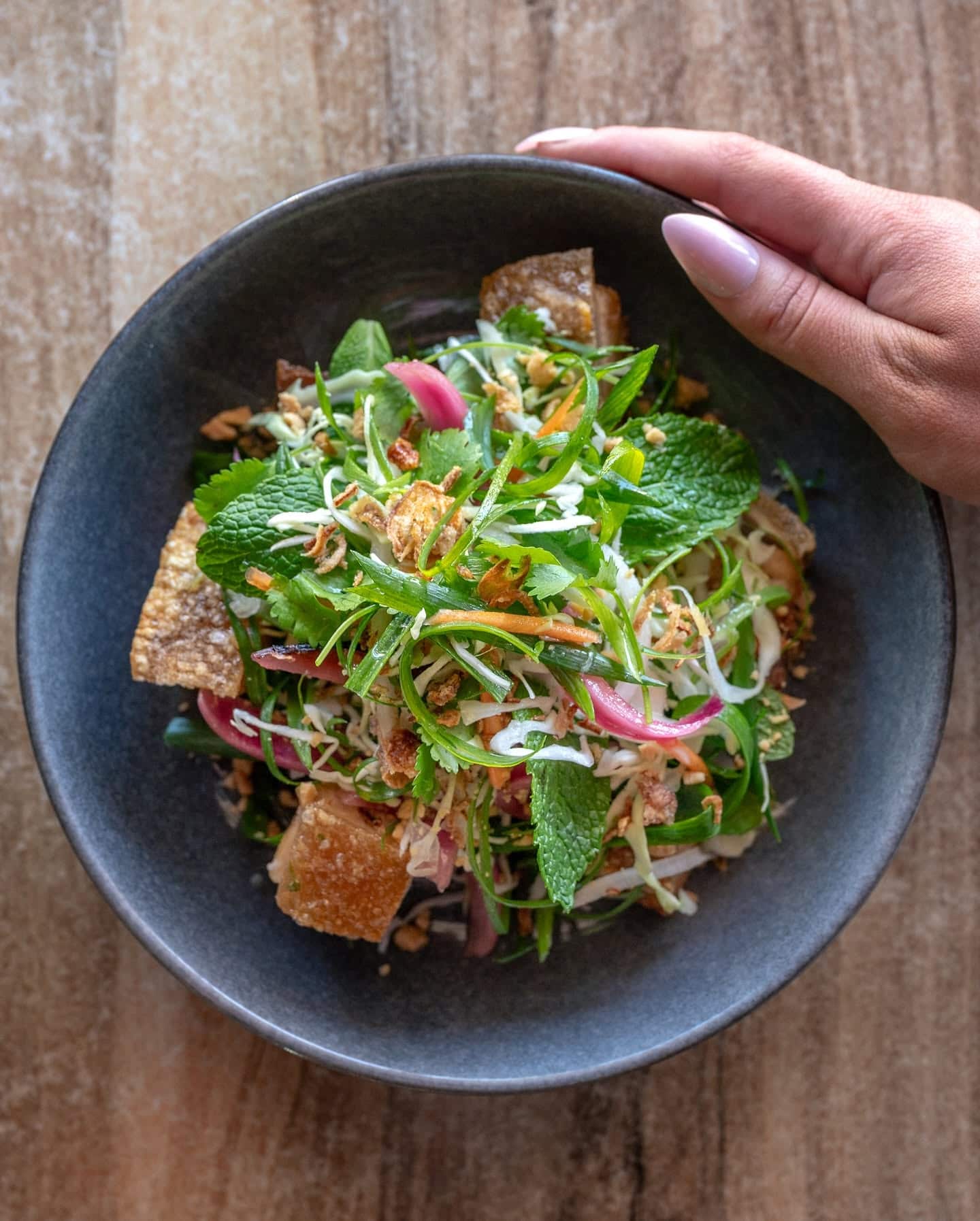 Fresh herb and cabbage salad with crispy elements and pickled onion served at Brass Monkey cafe in Mildura.