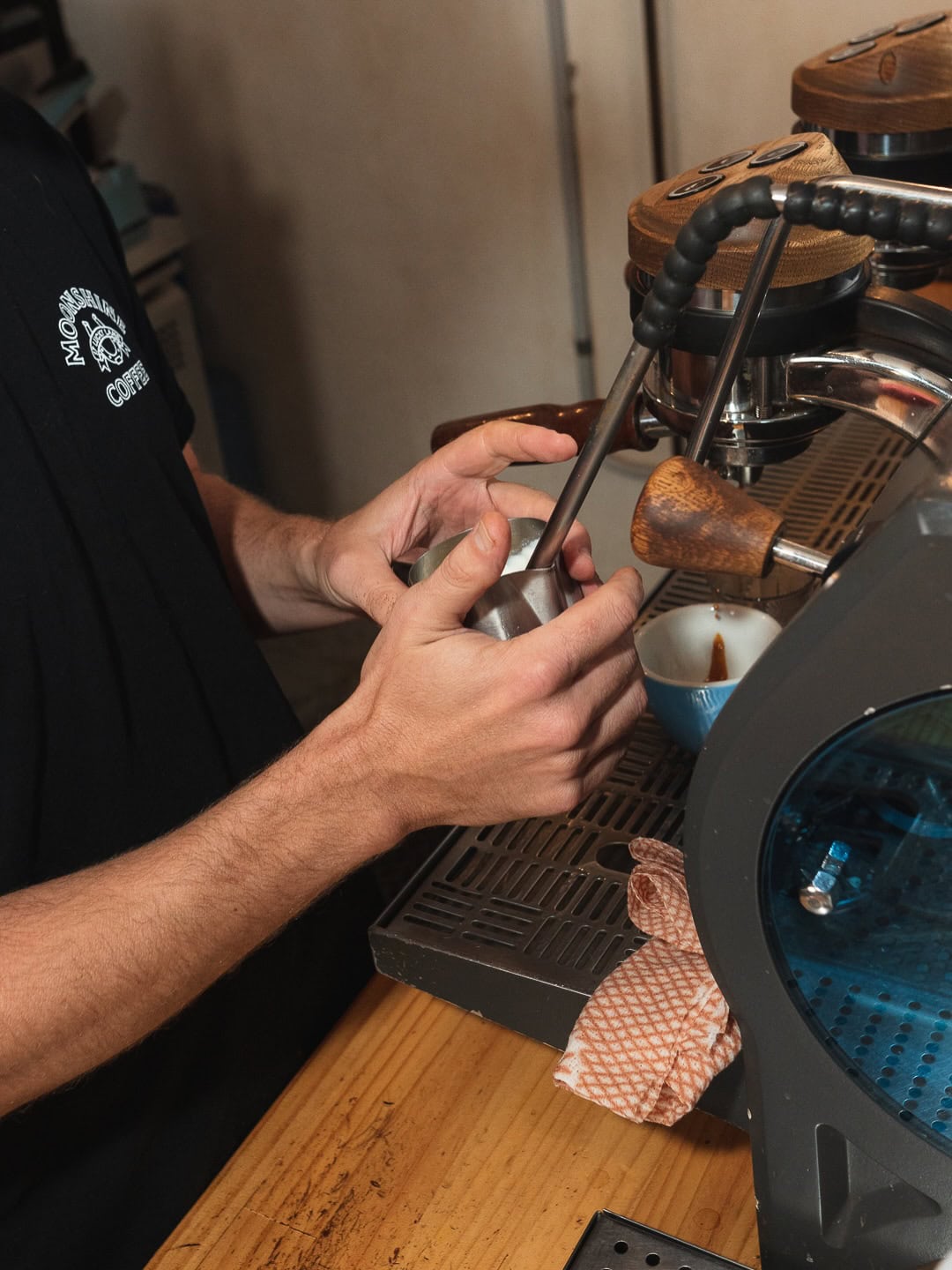 A barista making coffee at Moonshine Coffee in Federal.