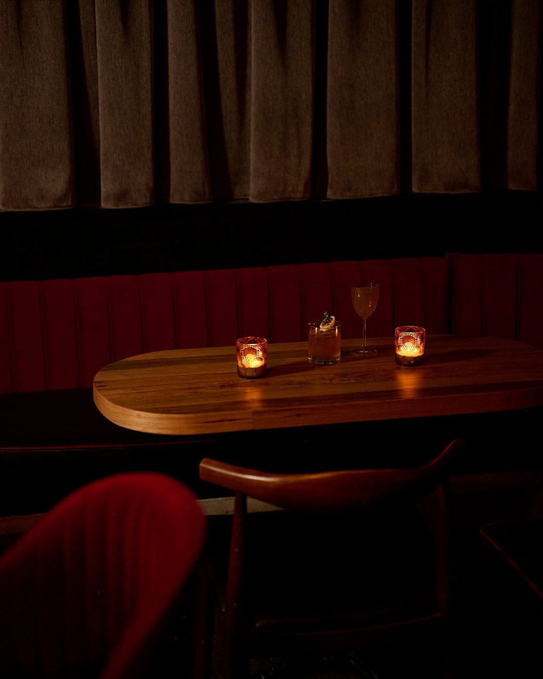 A corner of the Devil You Don't dining room in Canberra lit by candles.