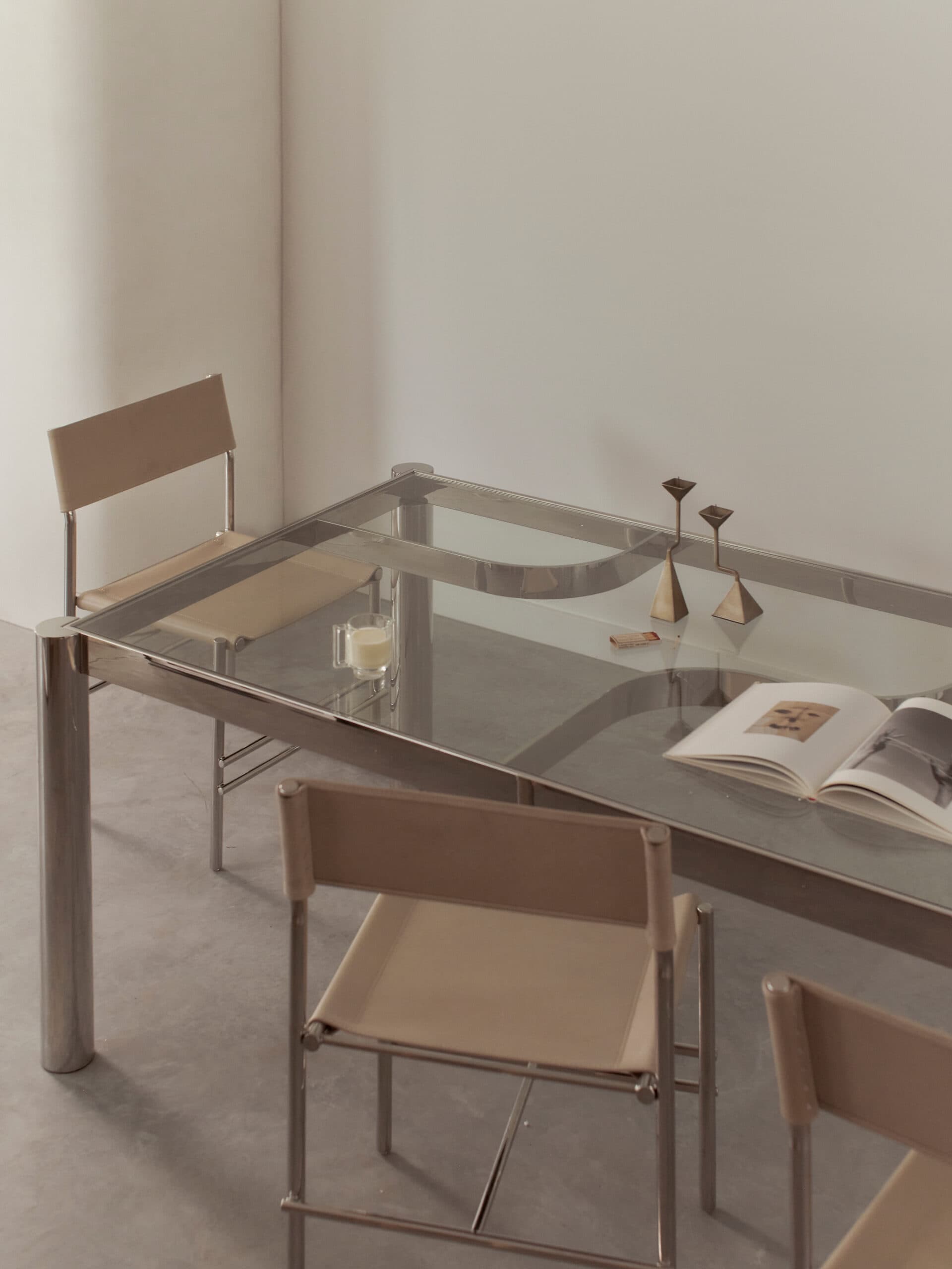 Dining setting with glass table and chrome chairs at McMullin & Co