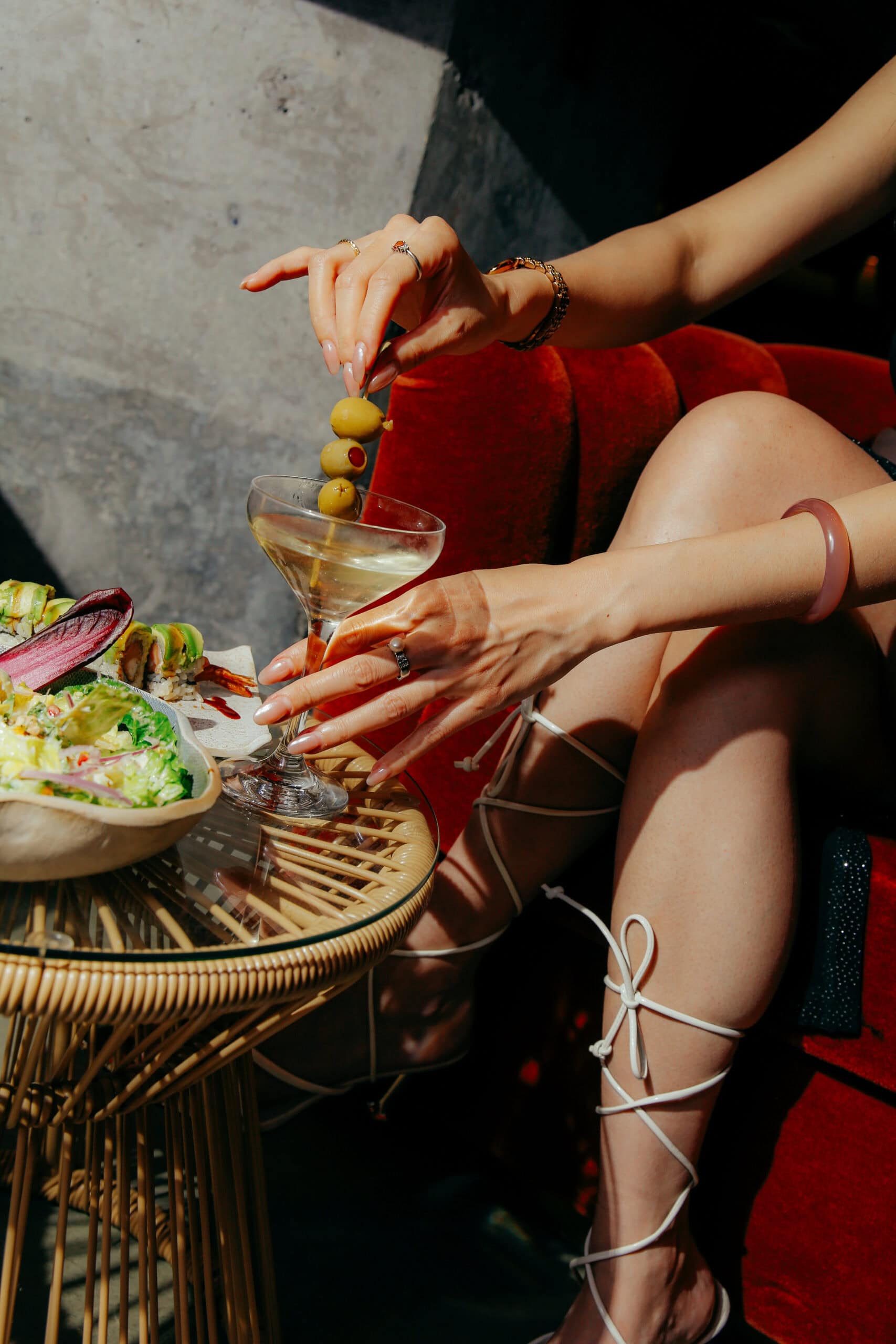 Dirty martini with olives beside sushi rolls and salad at Chotto Matte, the Japanese-Peruvian Nikkei restaurant opening in Bondi Sydney
