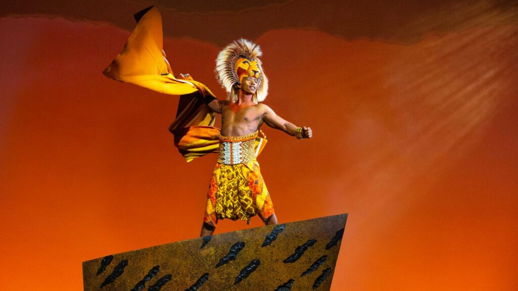 An actor playing a lion in Disney's The Lion King musical.