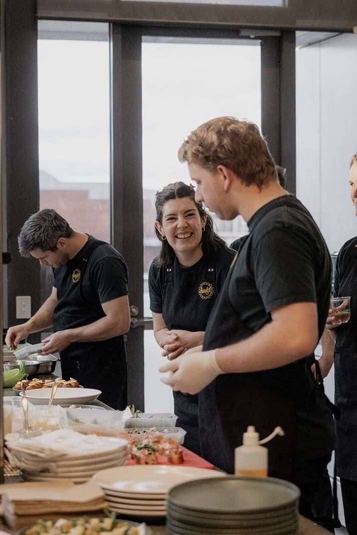 Colleagues laughing together at Hamlet cafe in Hobart