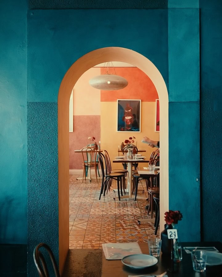 An arch leading through to another dining room at Parwana in Adelaide.
