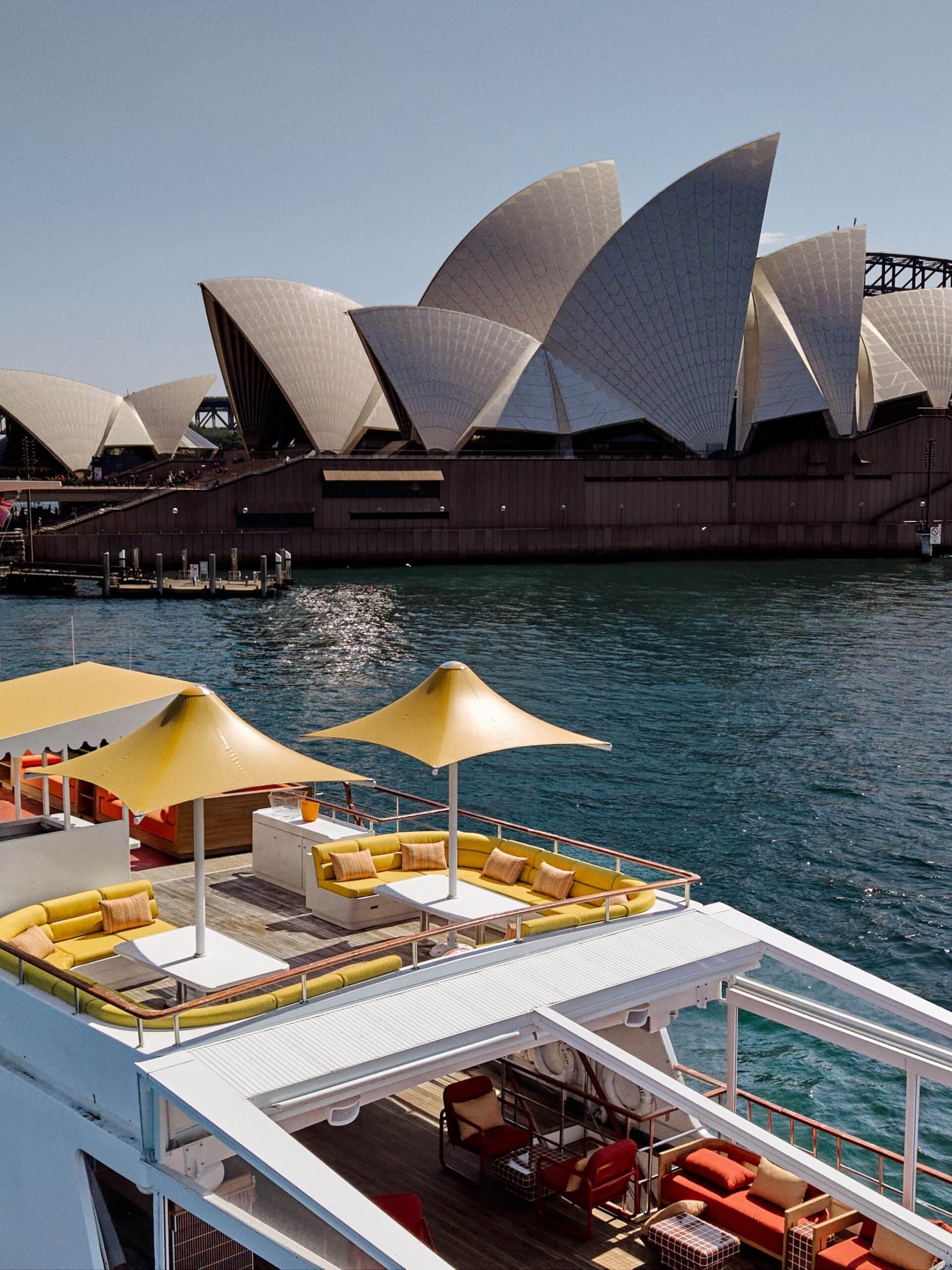 Rooftop deck lounge seating aboard the Solare superyacht with Sydney Opera House in the background