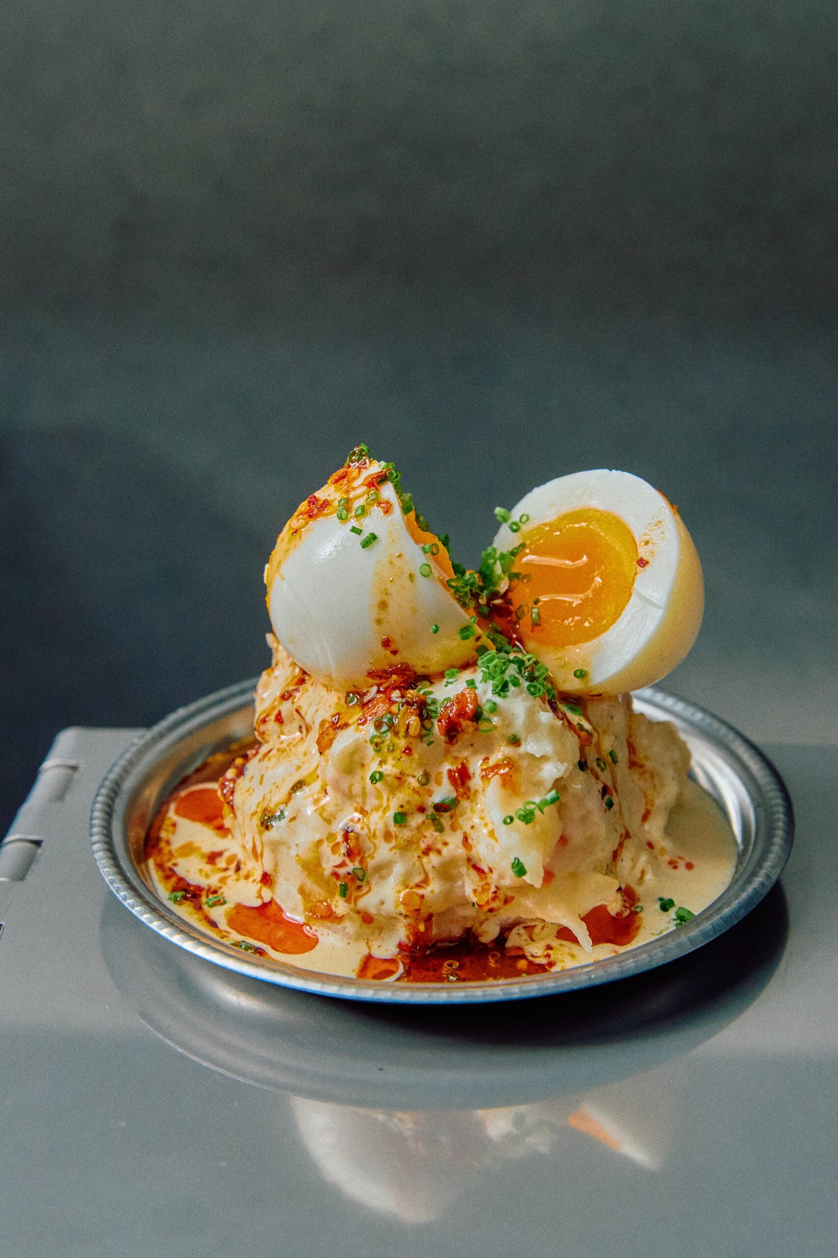 Soft boiled egg dish with chilli oil and chives at Tenjo The EVE Hotel Redfern Sydney