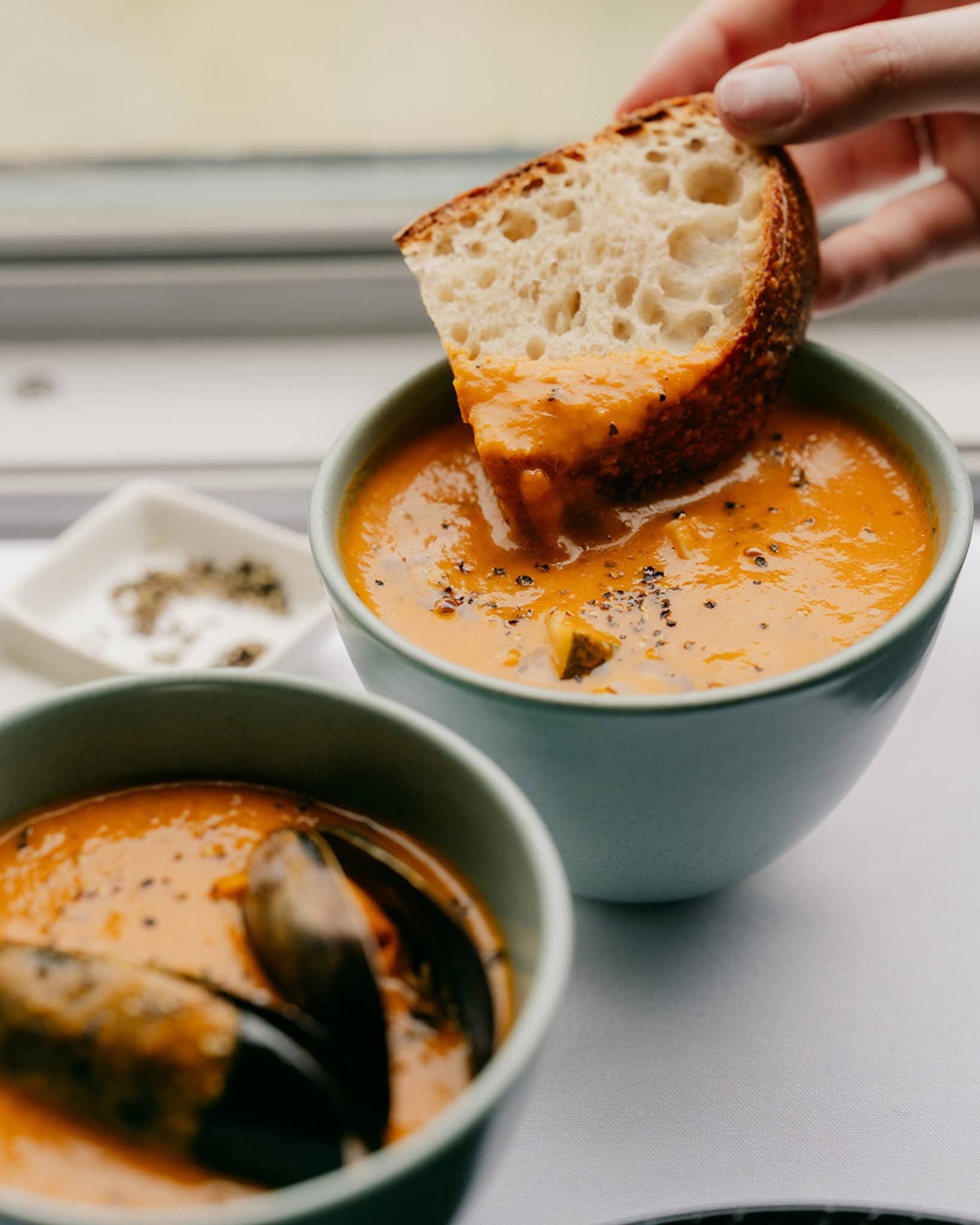 Seasonal soup and mussels served with sourdough aboard The Q Train, with Bellarine Peninsula views from the window.