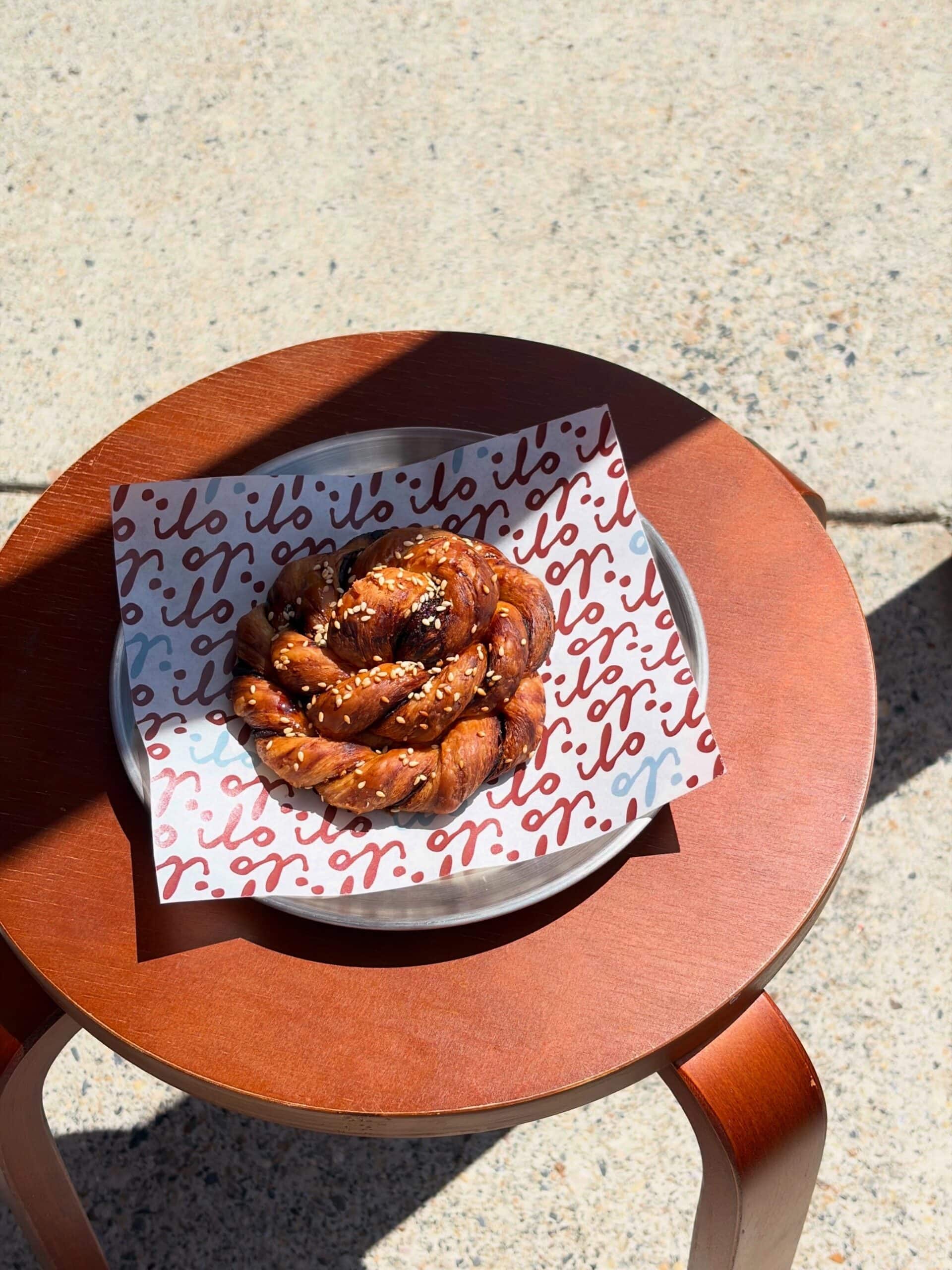 A Vegemite & Hot Honey Knot sitting atop a stool at Ilo in Wynnum.