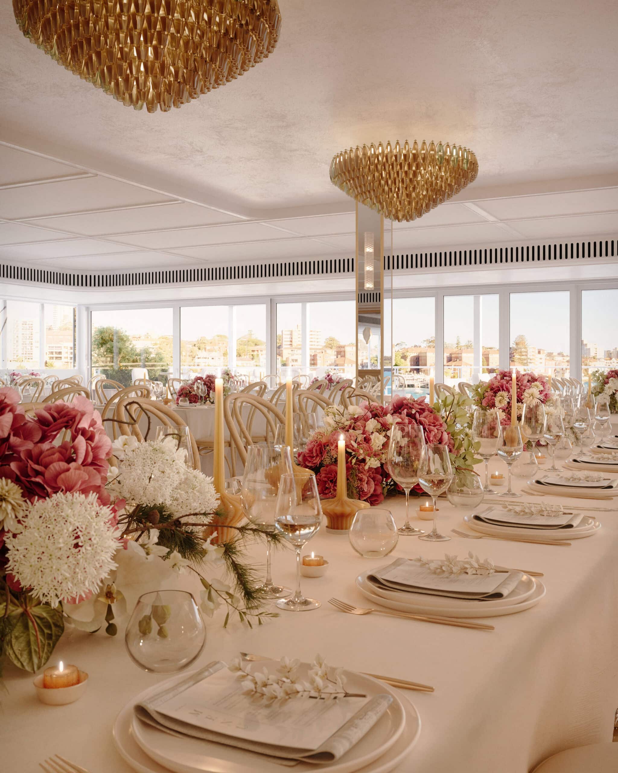 Artist's impression of a wedding reception long table with florals, candles and Murano glass chandeliers at Shelly Room, Manly Wharf Sydney