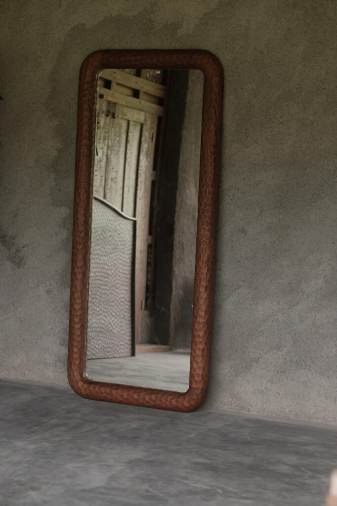 Brown framed floor mirror by worn