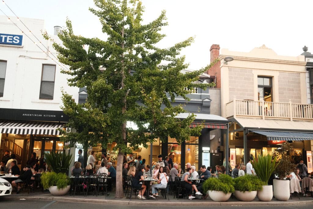 People eating on the pavement in Adelaide CBD.