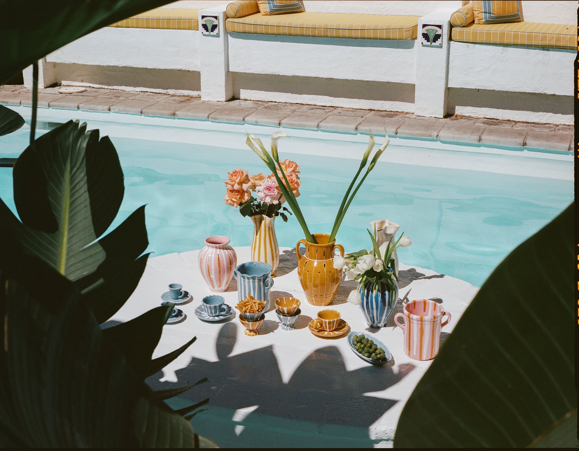 Alex and Trahanas x Raes Summer Vacanza ceramics lined along a curved terrace wall at Raes on Wategos hotel, Byron Bay