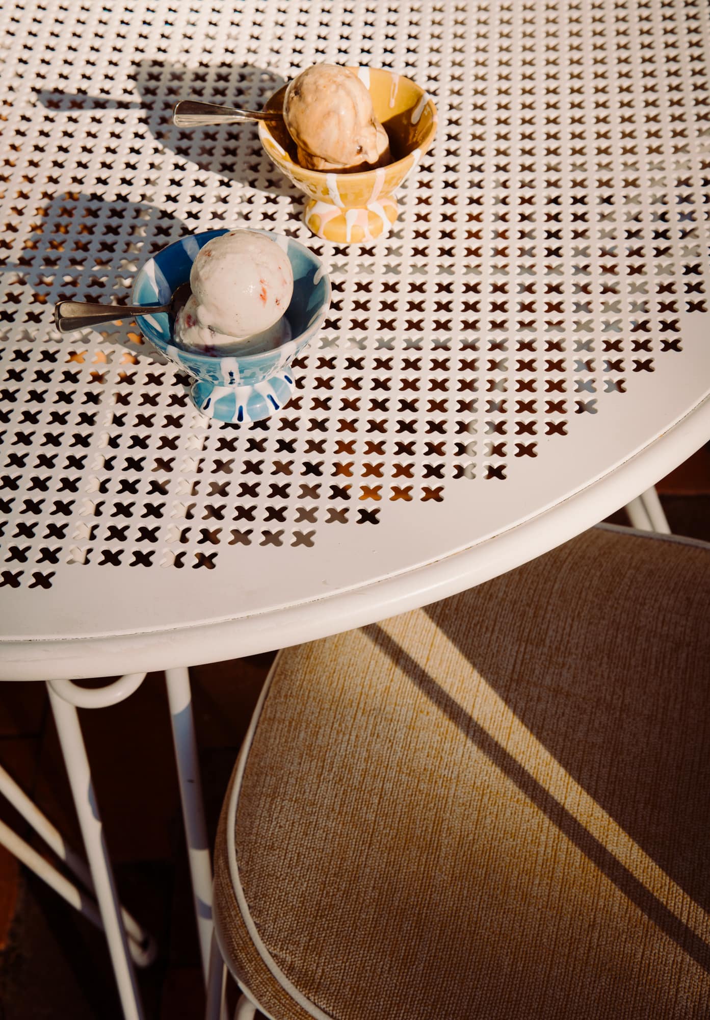 Honey and blue Alex and Trahanas x Raes gelato cups filled with gelato on an outdoor table at Raes on Wategos, Byron Bay