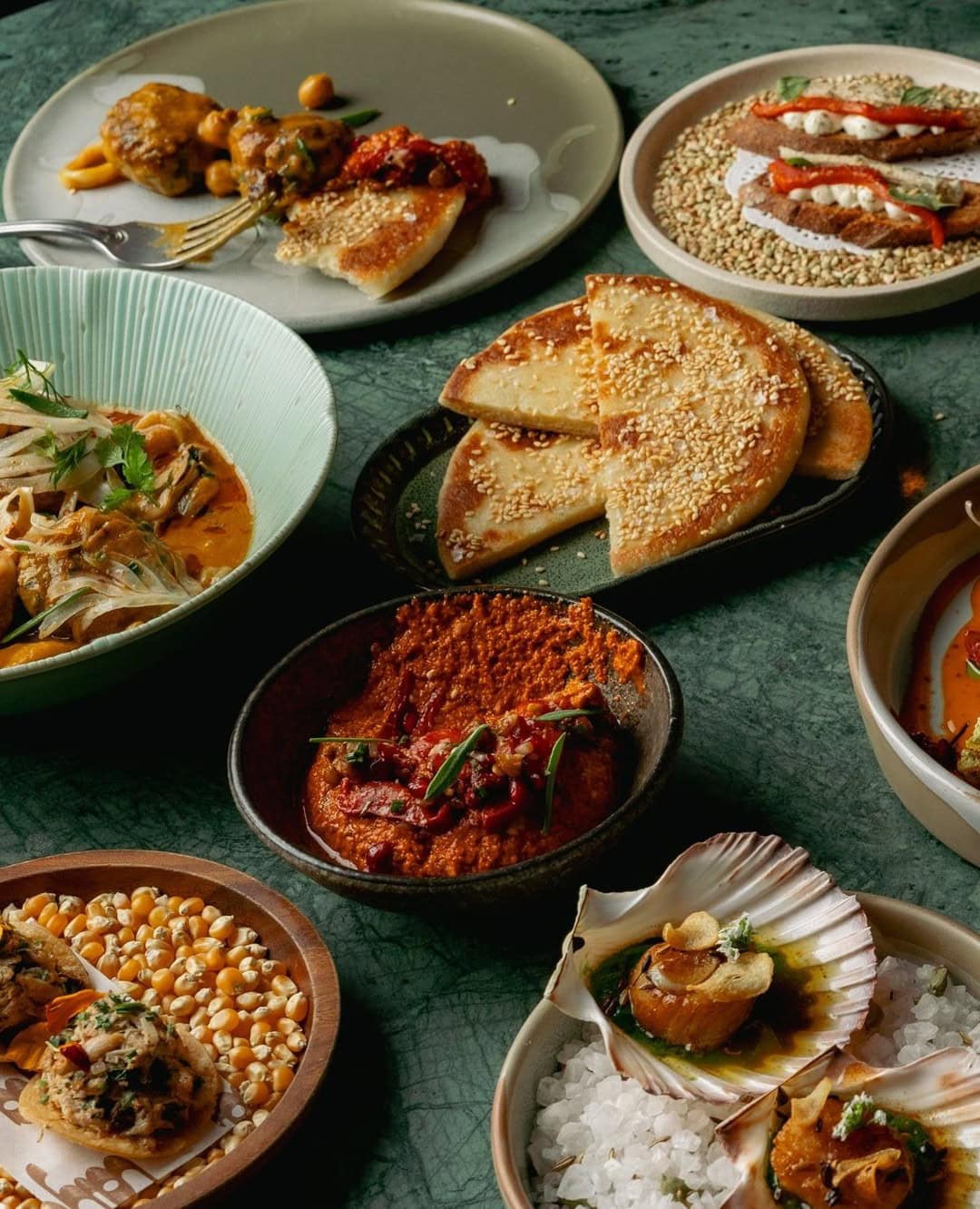 Banquet share plates on a green table at Layla West End.